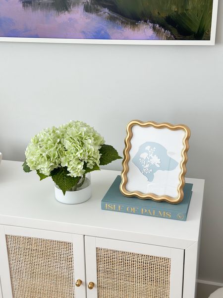 Living room console styling featuring my new “blank book” from Pastel Proper! You can get pretty much any city name customized & it would make a great gift! 

Grandmillennial, coastal Grandmillennial, silhouette, fake hydrangeas, coastal home decor, living room decor 

#LTKhome #LTKstyletip