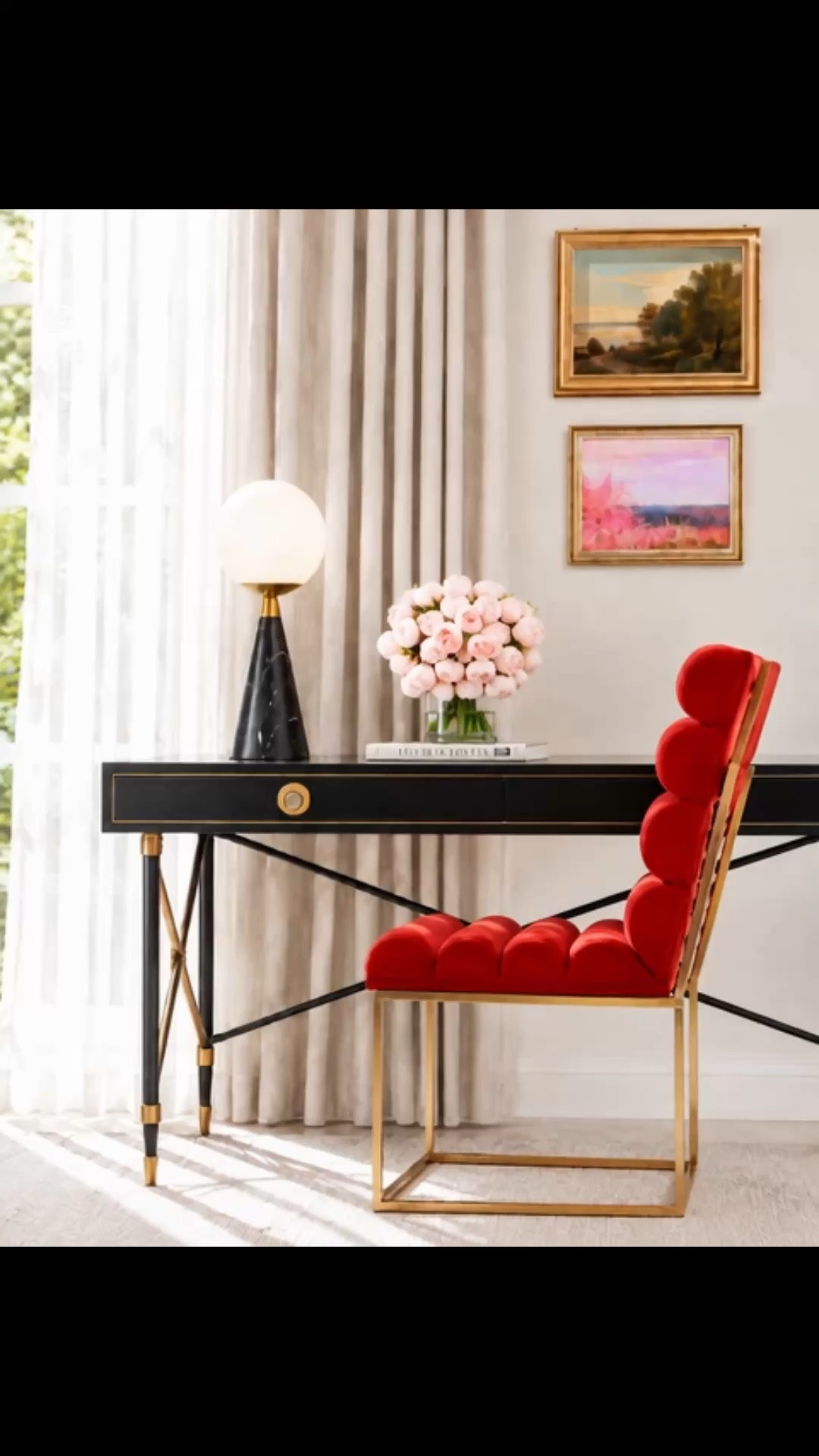 A polished home office designed to feel collected, comfortable, and inspiring. The black-and-gold writing desk creates a strong classic foundation, while the layered artwork brings color and personality to the wall. Soft drapes frame the window, filter the natural light, and make the workspace feel calm and comfortable throughout the day. The textured rug adds warmth underfoot, the sculptural globe table lamp introduces a modern contrast, and the blush flower arrangement brings an uplifting touch to the desk. The statement red roller-design chair is the standout—the plush rounded cushioning looks exceptionally comfortable while giving the room a bold, fashion-forward edge. A beautiful workspace for a stylish back-to-school season.

#HomeOffice #Artwork #Drape #DrapedChair #WritingDesk #OfficeChair #Rug #TableLamp #FlowerArrangement #BackToSchool

#LTKdayinmylife #LTKHome #LTKPlusSize