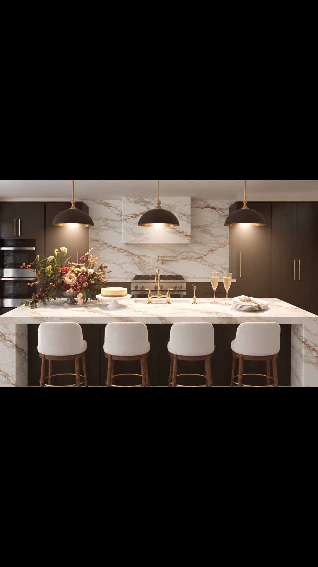Holiday entertaining starts in the kitchen! ✨🥂 It’s time to refresh your kitchen island and elevate your holiday gatherings with beautiful lighting, elegant seating, and thoughtful details.

I love how the rich French Press Coffee cabinetry pairs with the dramatic marble waterfall island, warm brass accents, and sophisticated Matte Mulberry pendant lights. As the pendants gradually illuminate, their soft glow washes over the marble countertop, creating a warm, inviting atmosphere for entertaining.

Add beautifully upholstered counter stools, a stunning floral arrangement, champagne glasses, and elegant serving pieces—and your kitchen island becomes the perfect gathering spot for family and friends.

Dinner will be served here! 🥂

#DinnerWillBeServed #ModernKitchen #KitchenDesign #KitchenInspiration #KitchenIsland #KitchenIslandDecor #KitchenRefresh #SlabCabinets #DarkBrownKitchen #FrenchPressCoffee #ColorOfTheYear2027 #PendantLighting #KitchenLighting #CounterStools #BarStools #BrassDetails #MarbleCountertops #WaterfallIsland #KitchenAppliances #Refrigerator #Freezer #KitchenSink #KitchenFaucet #PotFiller #KitchenRange #FloralArrangement #CakeStand #ChampagneGlasses #Entertaining #HolidayDecor #HolidayGetTogether #HolidayEntertaining #GatheringSeason #ModernChic #LTKHome #LTKStyleTip #LTKSeasonal #LTKSaleAlert