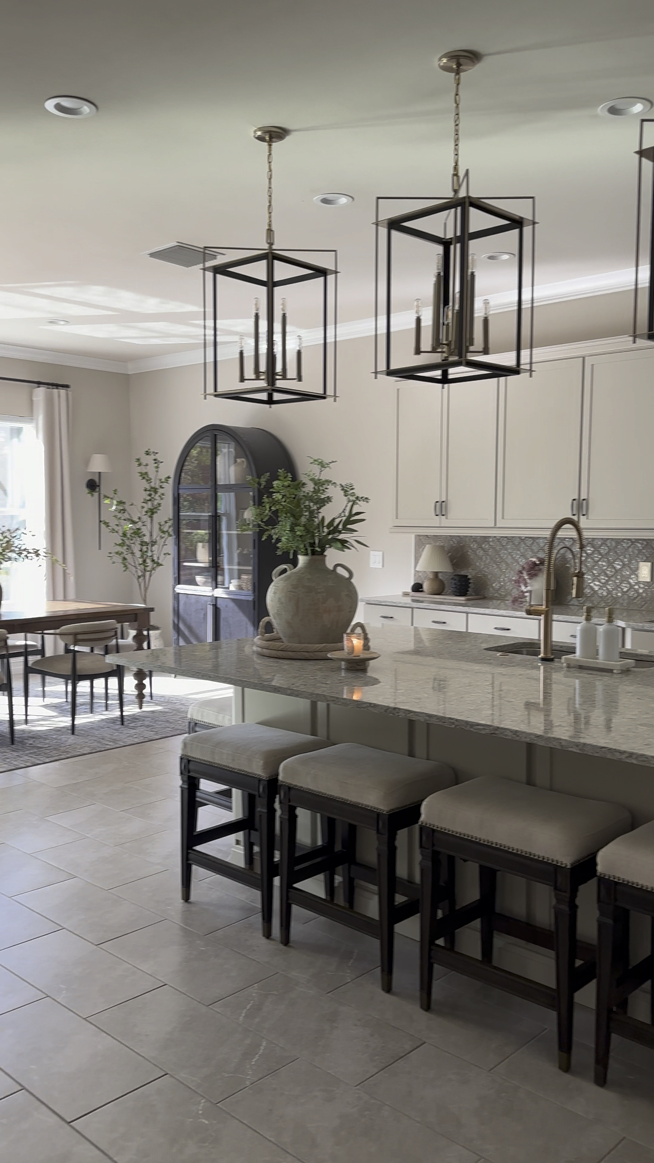 I love the way the natural sunlight pours in here in the evening! After getting my new dining chairs, I feel like this space is exactly how I envisioned it. 

Jagger, dining chairs, Arhaus, dining chairs, turned table legs, Hattie cabinet, black, arch cabinet, frontgate, barstools, Oversized island, kitchen, pendant, lights, CB2, vase, nearly natural tree, Z Gallerie sconce

#LTKhome