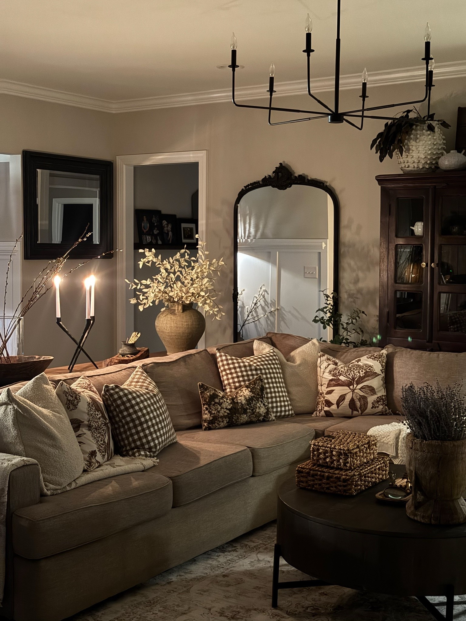 Nighttime living room view🥰

Spring home.
Vintage mortar, dried lavender, console table, ottomans, black candelabra, vintage wood bowl, vintage wood tray, glass cylinder, pussy Willow stems, round coffee table, woven storage boxes, vintage inspired living room rug, floor lamp with woven shade, small vintage clay pot, matches, large taupe vase, cream eucalyptus, spring pillow covers, pillow inserts, floral throw blanket, vintage inspired floor mirror, chandelier, sectional

#LTKSeasonal #LTKstorytime #LTKHome