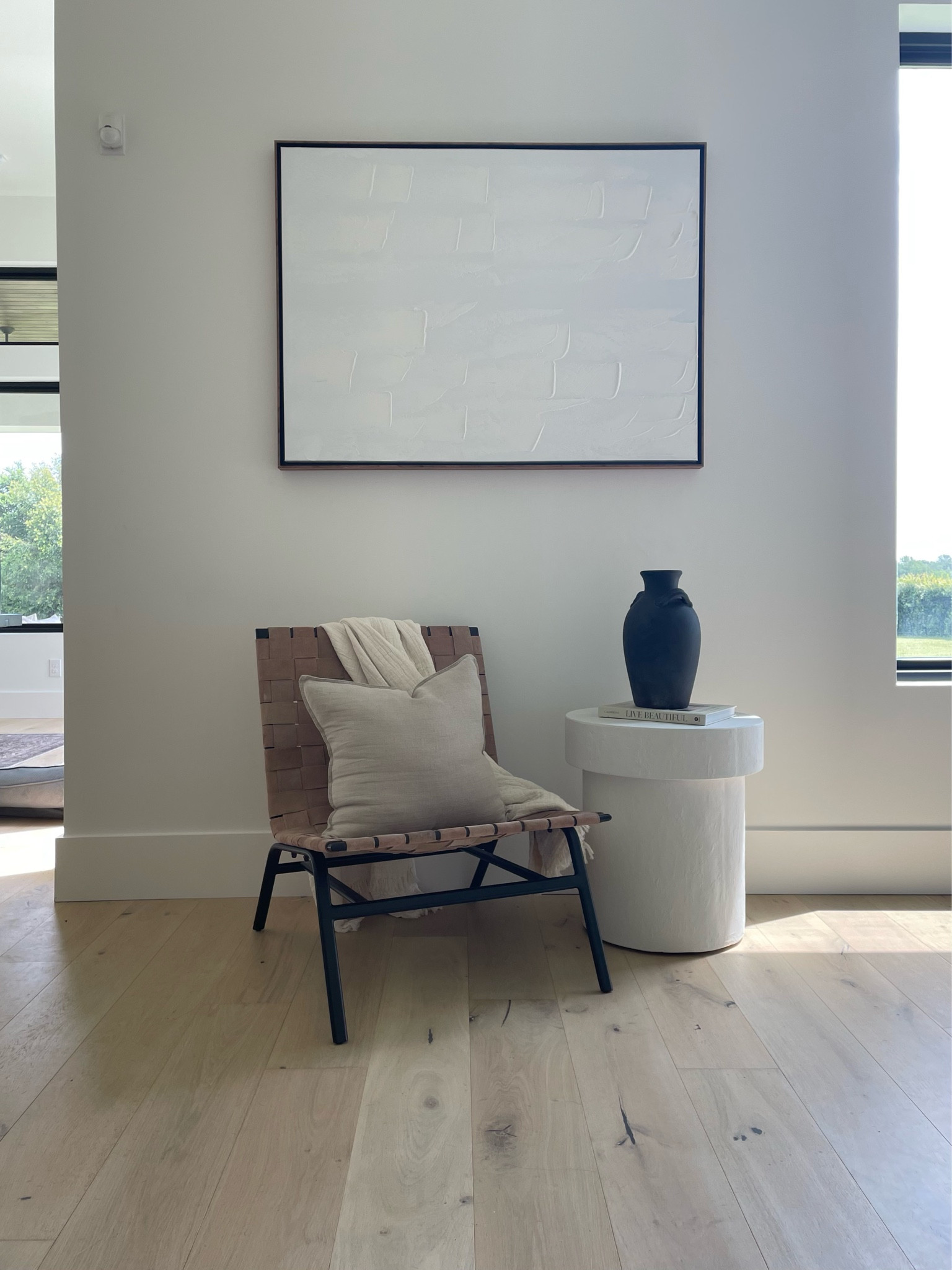 Sitting area. Reading nook. Coffee spot. Leather chair. Neutral art. White end table. Black vase. Coffee table books. 

#kellerandoak #amazonhome #targethome #potterybarnhome 