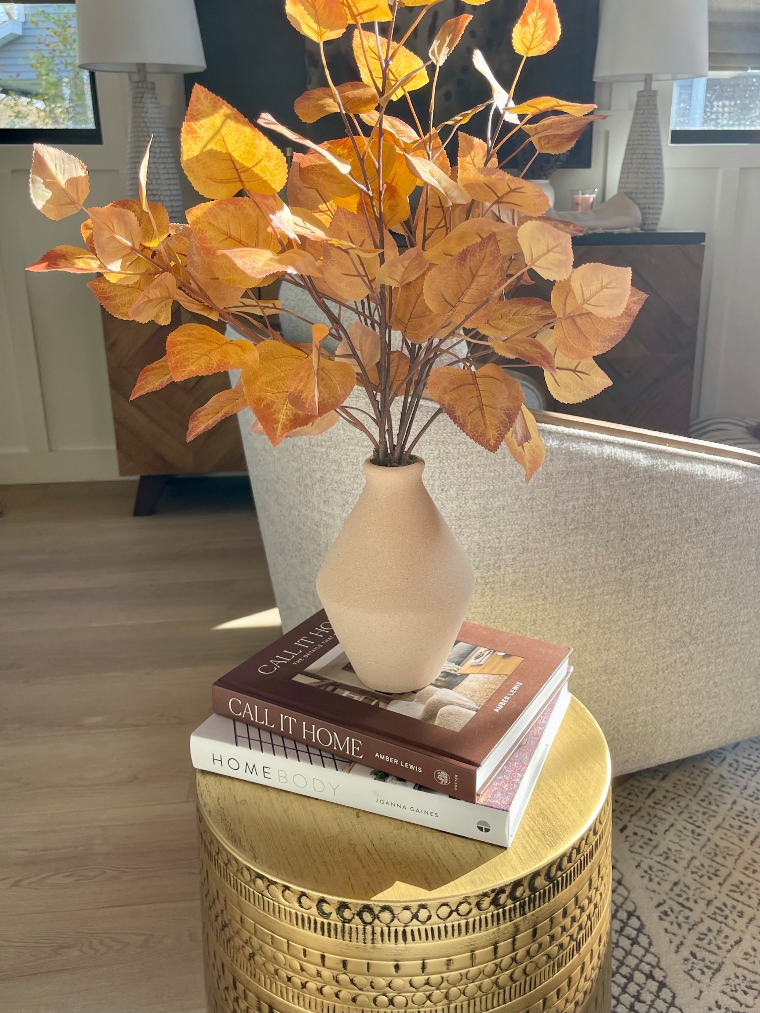 Fall home decor ! Leaves in a vase make for the perfect accent piece! Love these stylish brass side tables! Wood accent swivel chairs & a gorgeous geometric console table. Lots of great storage ! Don’t forget to add books for height!
#homedecor #falldecor

#LTKStyleTip #LTKSeasonal #LTKHome