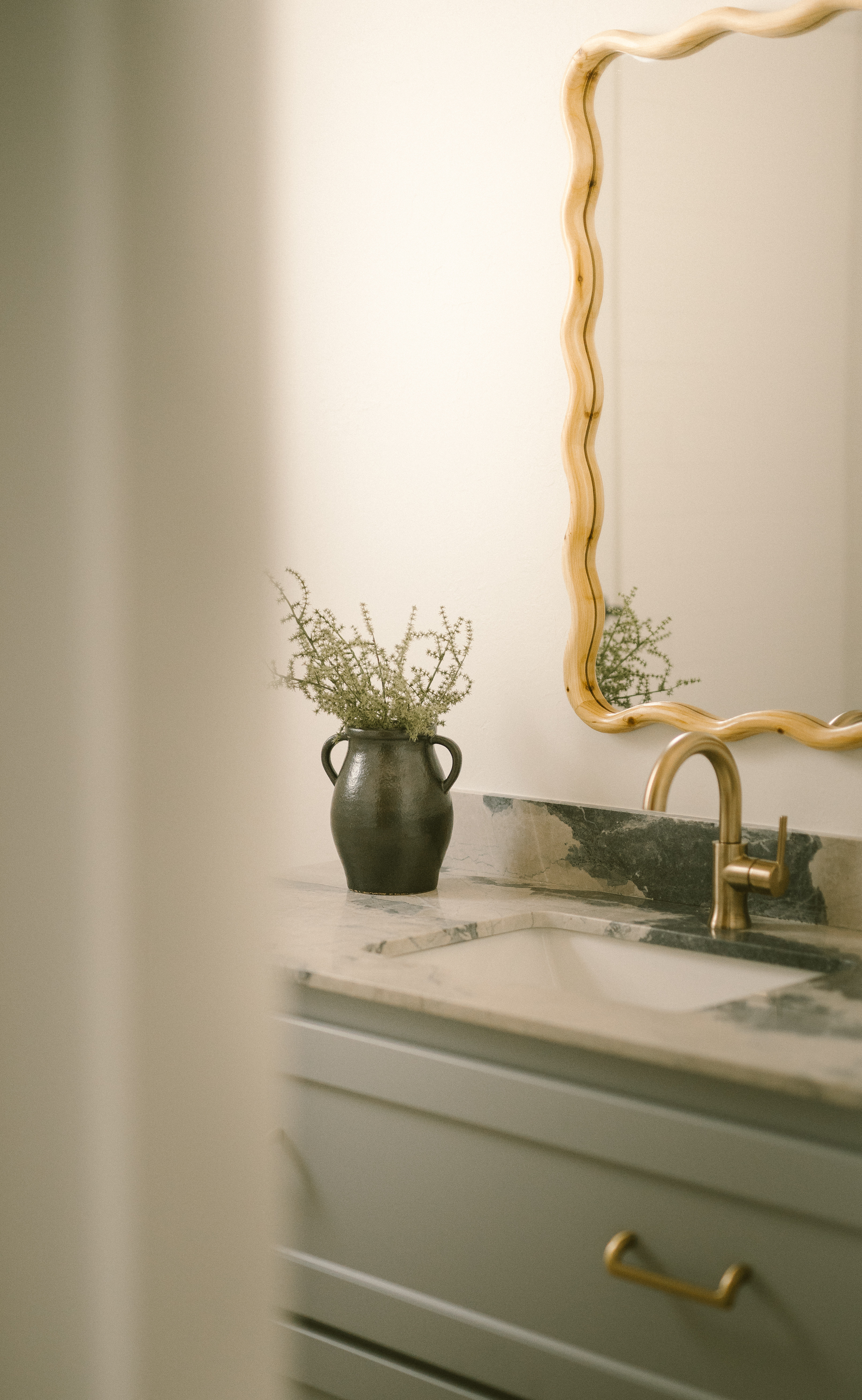 I used this wavy wood mirror to bring warmth and a playful shape to an otherwise clean and tonal space. It’s an easy way to soften a vanity without overthinking the styling. Tap to shop this exact mirror!! 

 #LTKHome