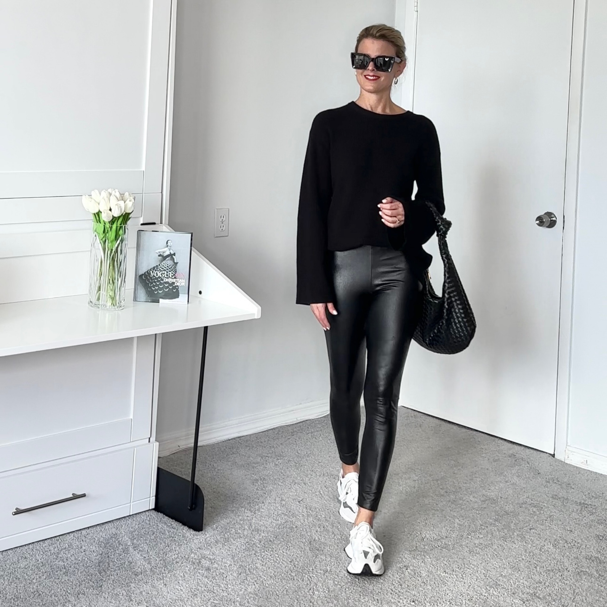 The sweater I'm wearing has a strange slit in the back, but I sorta like it.    I tuck on half in and that gives sone coverage.    I do think it's a highly returned item.    I linked sone alternatives if a back slit isn't for you.       If you want a larger fit sizing up 1 or 2 sizes will give you an oversized longer look.

The sneakers run a little larger then other new balances.    Sizing down a half size might be batter idea.  