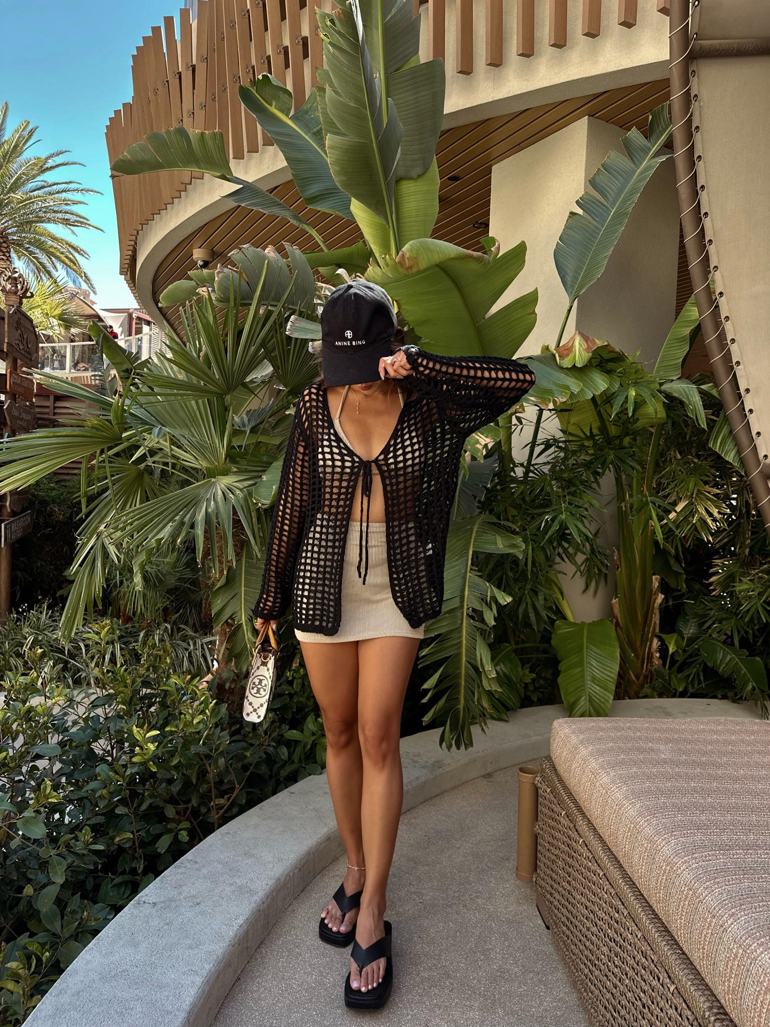 Vegas day club outfit: open knit cover-up layered over a striped bikini set, finished with a cap and thong platform sandals with mini tote bag

#LTKSwim #LTKSummerEdit #LTKTravel