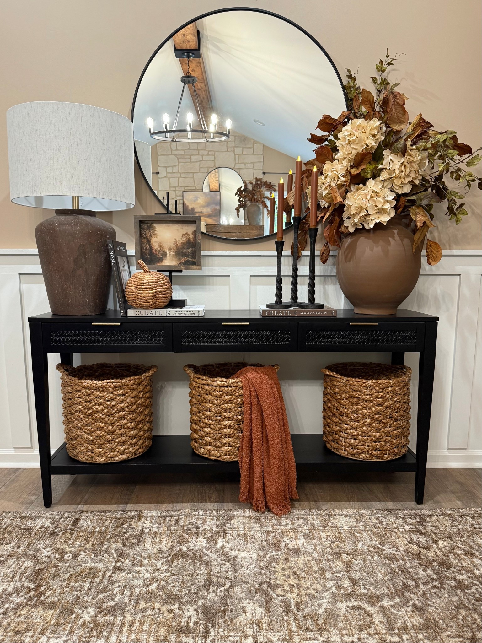 🍂✨Cozy & Classic Fall Console. 

Follow @farmtotablecreations on Instagram for more cozy home inspiration.

For reference:
•7x9 artwork in Briarsmoke stain. Use code FARMTOTABLE for 15% off. 
•Oversized Vase Florals:
3 Magnolia Stems
4 Cream Hydrangeas 
2 Grape Ivy Leaf Branches

This console is all dressed up for fall with layers of warmth and texture 🤎 From the oversized vase filled with rich autumn stems to the woven baskets, textured lamp, and cozy throw, every detail adds depth and coziness to the space. I love using stacked books and candleholders to bring height and balance, making it feel collected yet functional.

These pieces are timeless staples that you can easily mix and match for any season, and most are from my favorite retailers — simple swaps like stems and throws make it easy to transition your look from season to season.

#fallconsole #entrywaytable #fallstyling #fallhomedecor #falltabledecor #consoledecor #fallvibes #baskets #fallflorals #tablelamp #candlesticks #throwblanket #autumnvibes #homedecorideas



#LTKFindsUnder50 #LTKSaleAlert #LTKHome