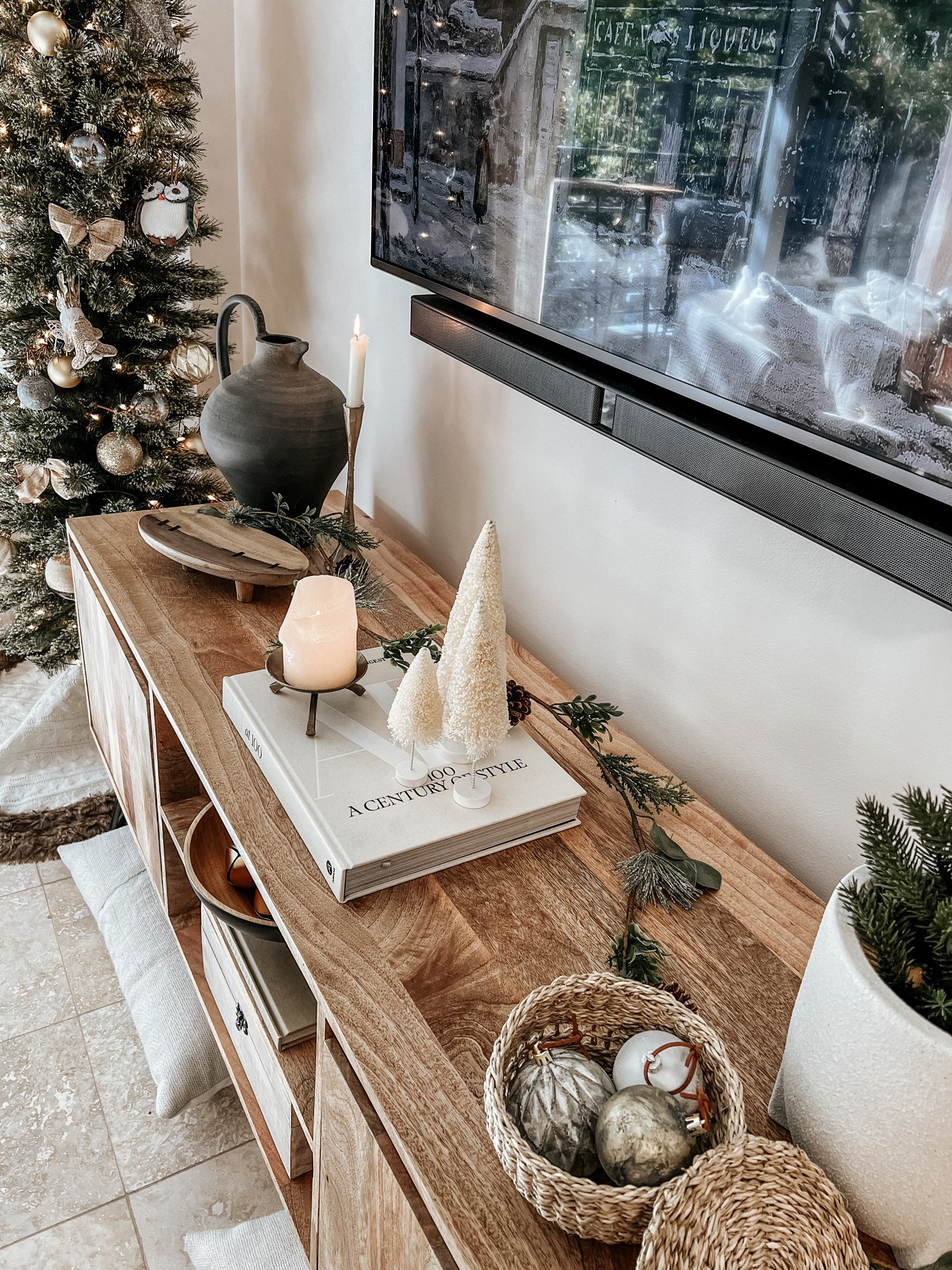 Tv console styling with neutral holiday decor 

Media stand. Tv console. Holiday decor. Neutral home. Neutral home decor. Vase. Decorative book. Christmas tree. Ornaments. Candle holder. Wood tray  

#LTKhome #LTKSeasonal #LTKHoliday