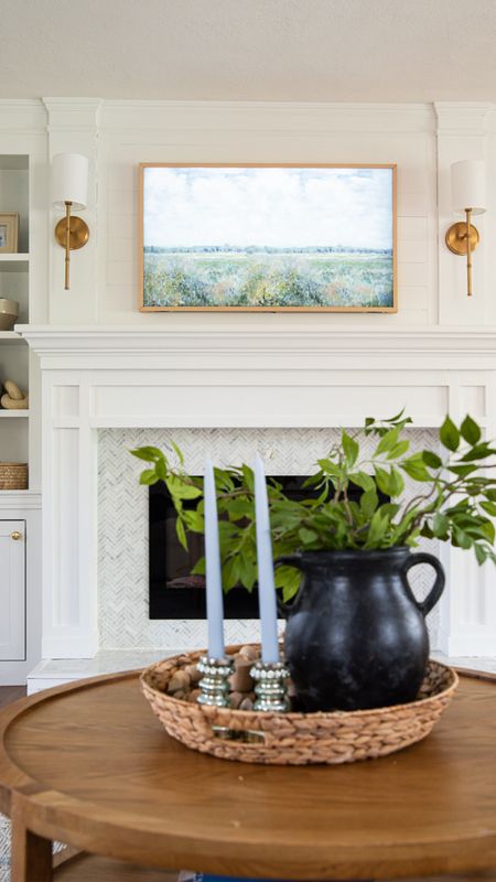 Coastal style home decor, living room, gold sconces, Samsung TV picture, ceramic vase, artificial plants, roundwood coffee table,

#LTKHome #LTKFamily