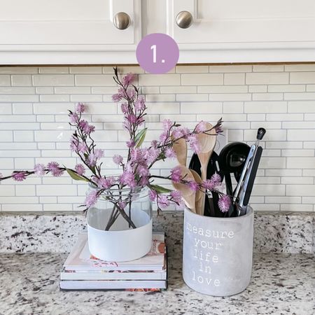 Colorful kitchen counter decor, perfect if you need help styling your kitchen counters.
Glass vase with purple flower stems
Utensil holder
Wooden spoons 
Cookbooks

#LTKunder50 #LTKhome