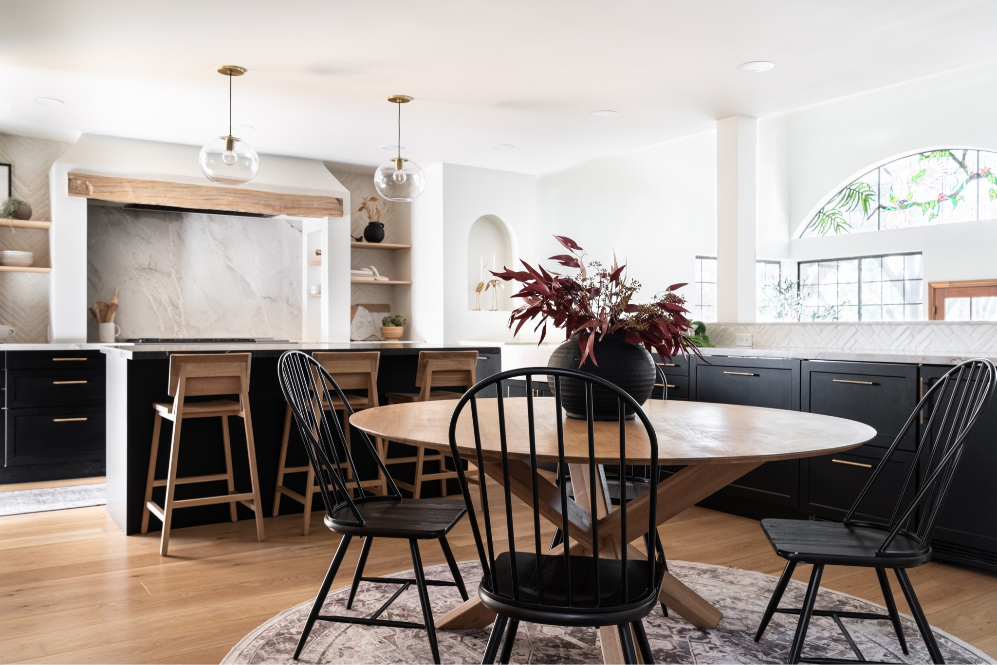 Neutral kitchen with black cabinetry and two toned counters with natural accents. #neutralkitchen #blackcabinets #modernkitchen 

#LTKhome #LTKunder100