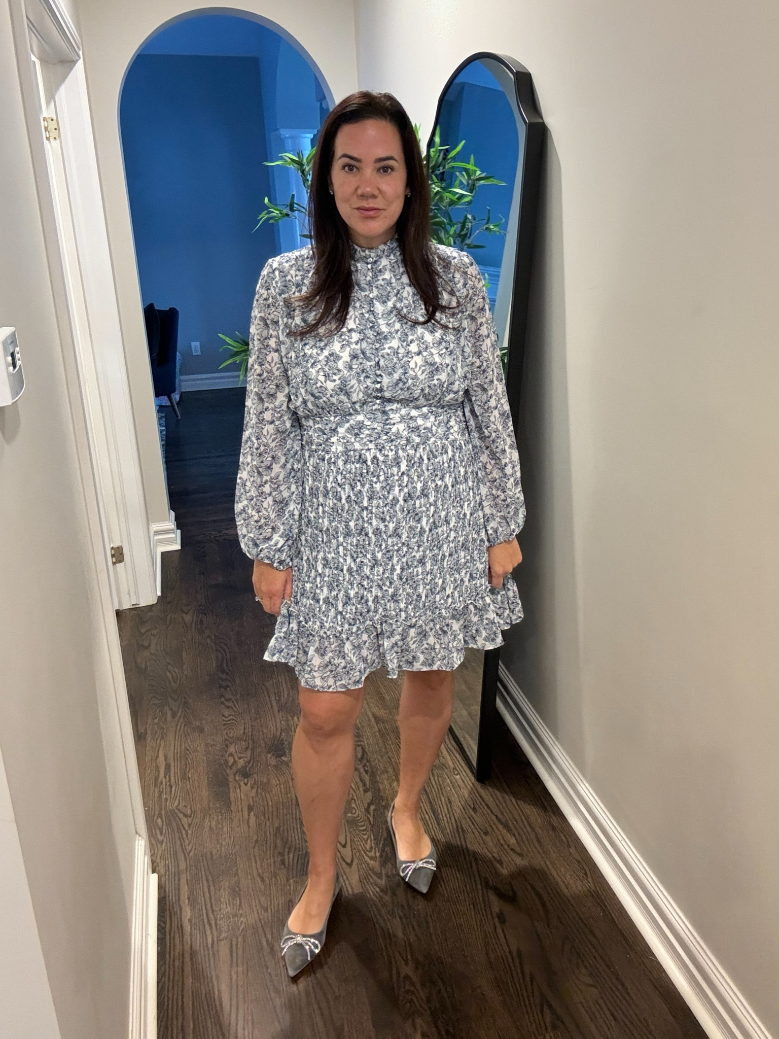 Plus size mid size dress work dress special occasion dress 

Ivy City Co. X Lindsay Arnold Exclusive

Feminine, flattering, and striking. The Brynley Dress is made out of the most exquisite fabric, a lovely blue floral print, pleated skirt, functional button down front, and blouson sleeves. She is ever so dreamy and will be your most repeated dress. She has the versatility to be dresses up or down.

Fit:

Base color is white with blue floral print
Long sleeves
Knee length, pleated skirt
High neck with a functional button down top
Blouson sleeves
Back invisible zipper
Fabric has no stretch
Nursing friendly
Fabric:

100% Polyester
Care:

Machine wash cold; lay flat to dry

#LTKworkwear #LTKmidsize #LTKsalealert