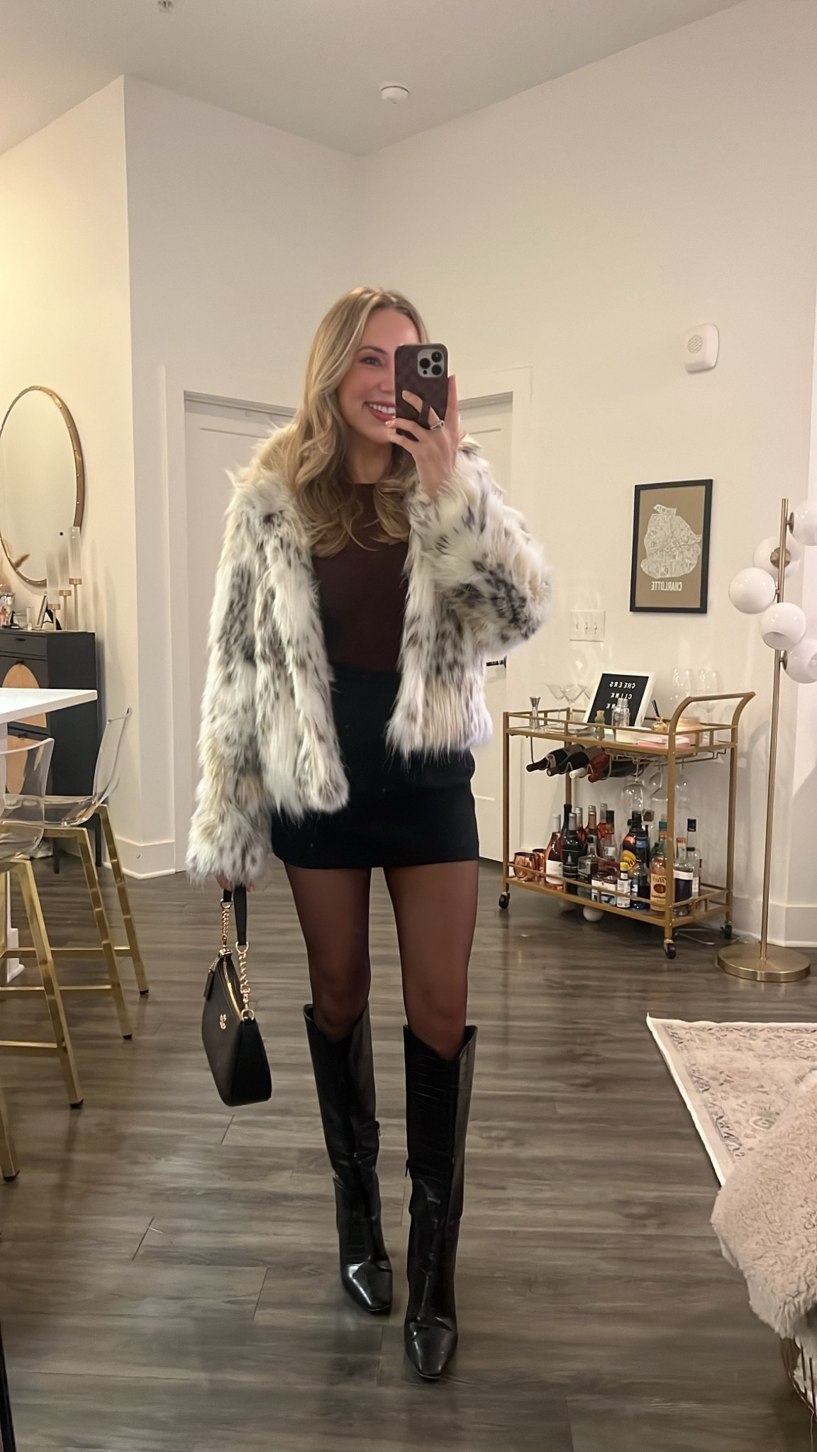 Girls night out black mini skirt, sheer tights, black knee boots, brown bodysuit, faux fur coat 

#LTKSeasonal