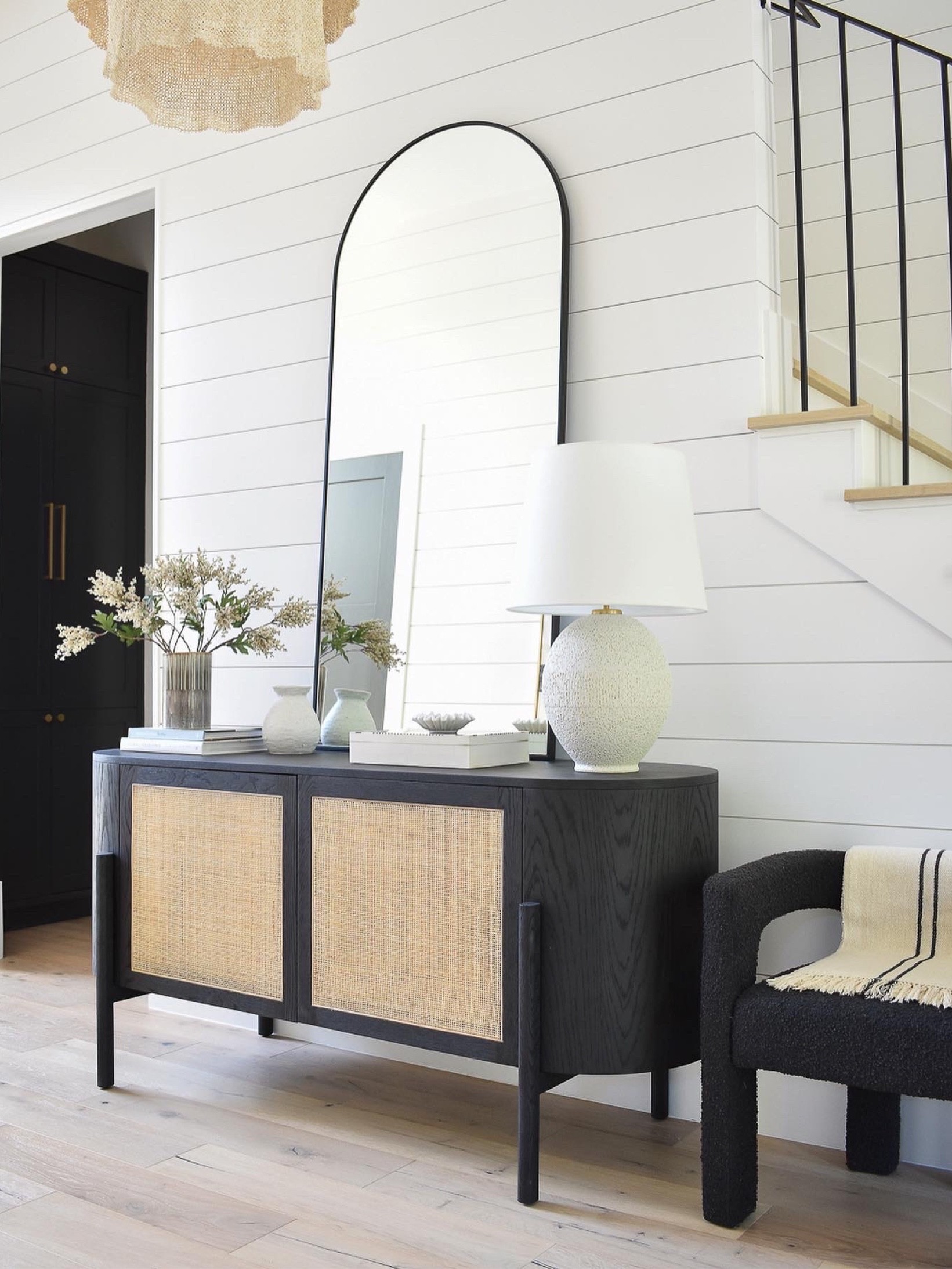 Fall decor.  Entryway.  Entryway decor.  Foyer. Foyer decor.  Black arched mirror.  Black cane credenza.  Cane buffet.  Cane furniture.  Black cream Boucle chair.  Fall stems. Fall branches.  Cream branches for fall.  White lamp.  

#LTKstyletip #LTKhome #LTKSeasonal
