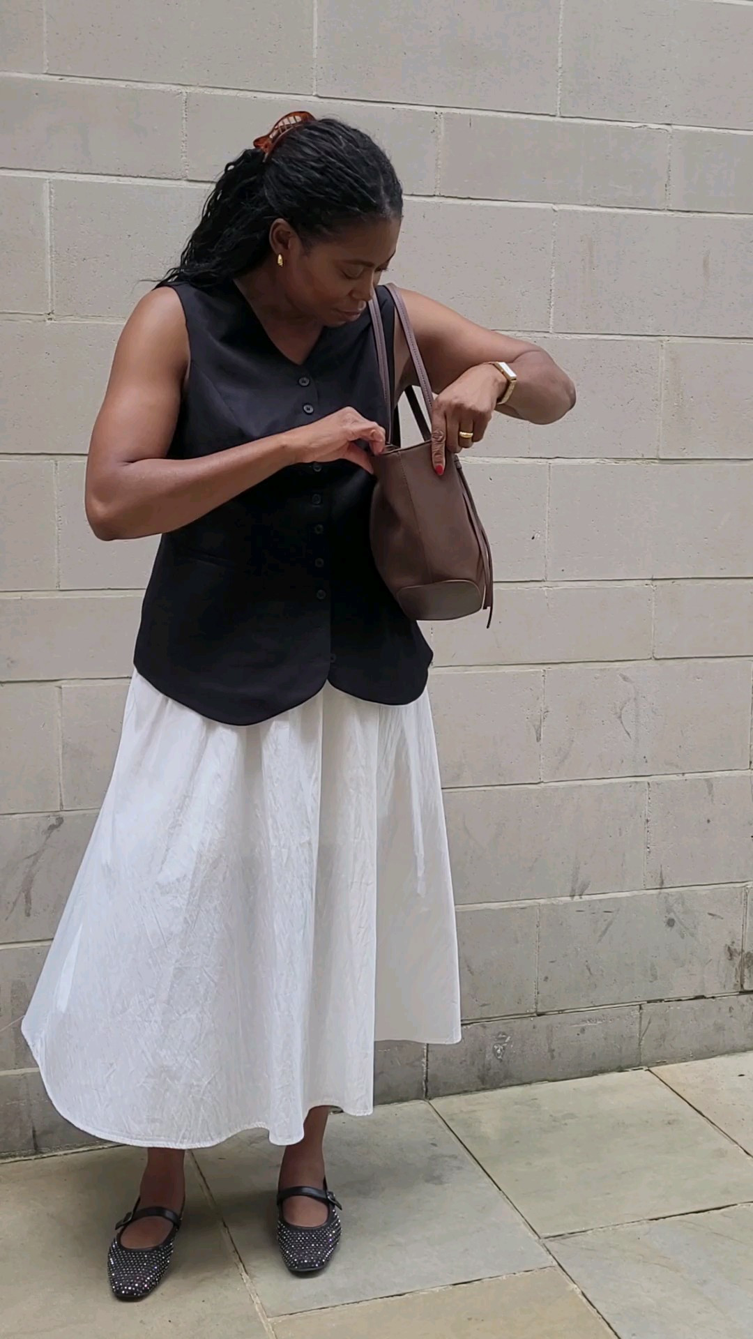 Monochrome outfit with a pop of brown 🤎Millennial mum outfit for Summer and Autumn 🍂White midi skirt, black waistcoat vest, black mesh Mary jane shoes and brown bag.Use code KLDTFJIW for 15% off Katie Loxton bags #ltkuk #autumnoutfits #fallfashion #summerstyle #momoutfit 

#LTKsummer #LTKautumn #LTKbag