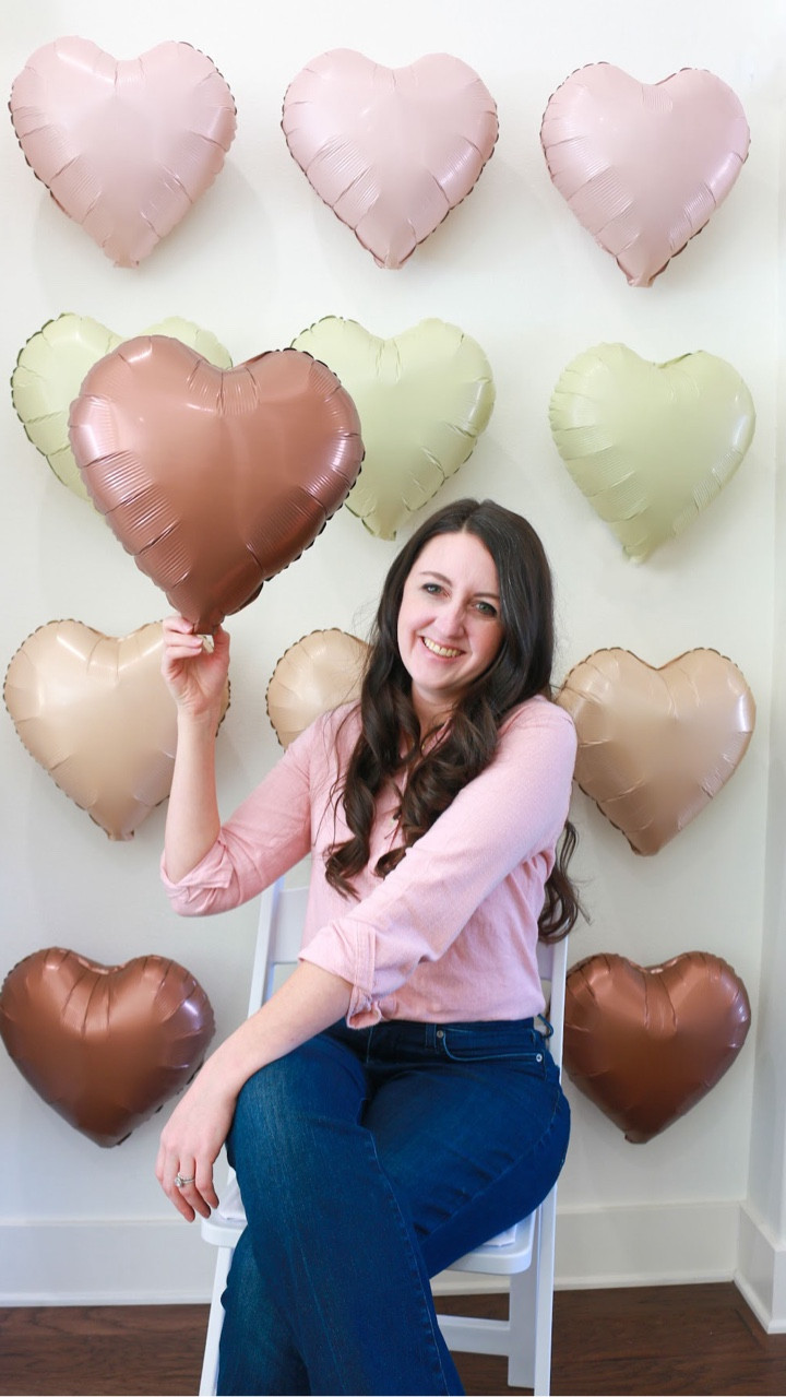 Welcome back to part 2 of setting up for my 2026 Galentine’s party! 

I started with setting up a Galentine’s photo backdrop using heart balloons I found on Amazon (linked below), using the straw it came with and an electric balloon pump to save my lungs. Then taped them in a row by color, saving one out for a cute photo prop. I find people don’t know what to do with their hands in pictures, so props help. 

Lastly, I set out the food & bingo Valentine’s prizes before guests began to arrive. 

Come back for the final reveal of how it all came together & the fun activities I had planned for this year’s Galentine’s gathering.
.
.
.
.
.
.
.
.
.
.
hosting diaries | hosting Galentine’s party | Galentine’s ideas 2026

#LTKSeasonal #LTKValentine