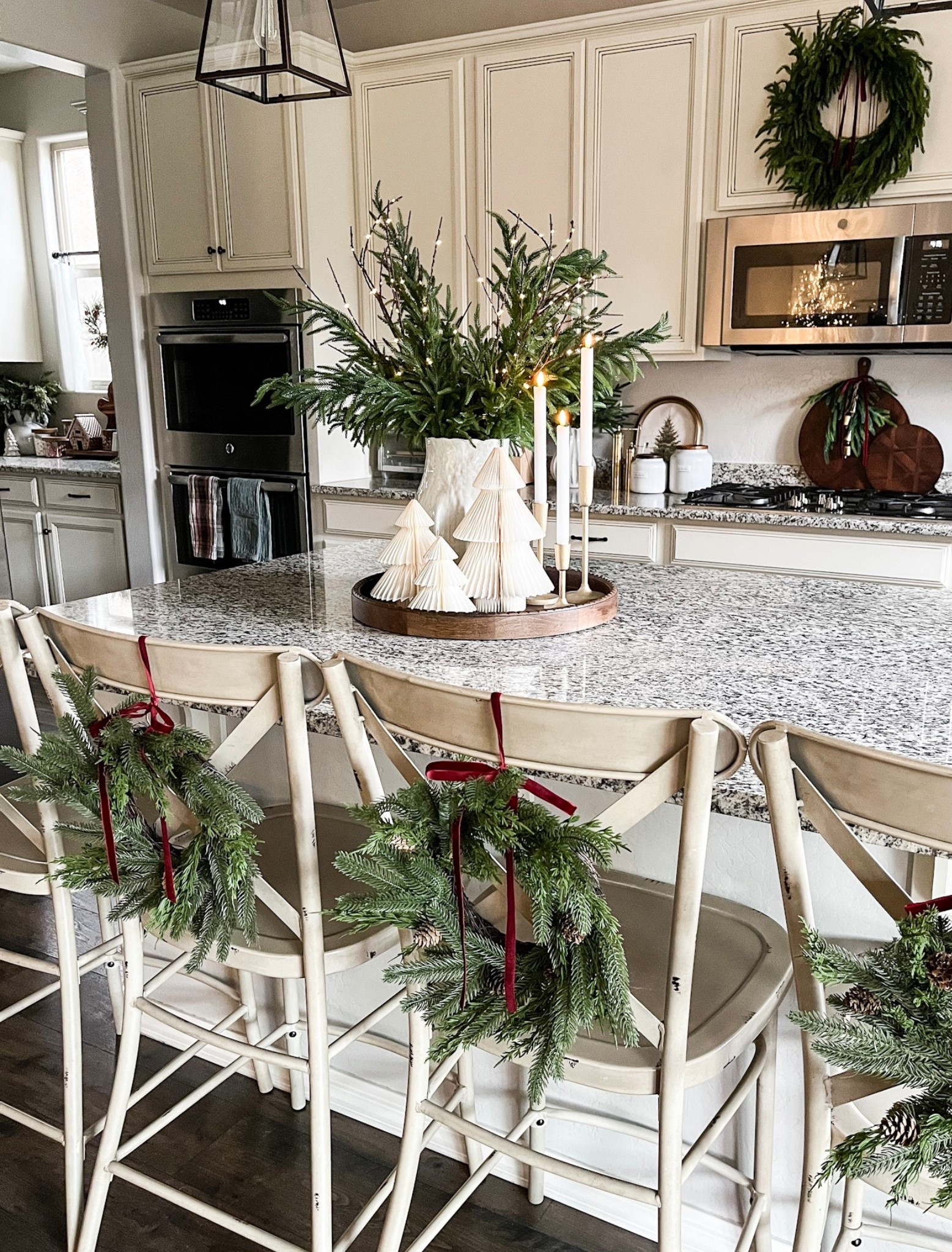 Mini wreaths!  Follow @lifeinmyarizonahome on Instagram for more holiday ideas and inspiration. 

These adorable mini wreaths are perfect for the back of my chairs at the kitchen island. I love the pine cone detail and the addition of the red ribbon that coordinates with the rest the room. 

#christmasdecor #christmaskitchen #miniwreath #holidaydecor 