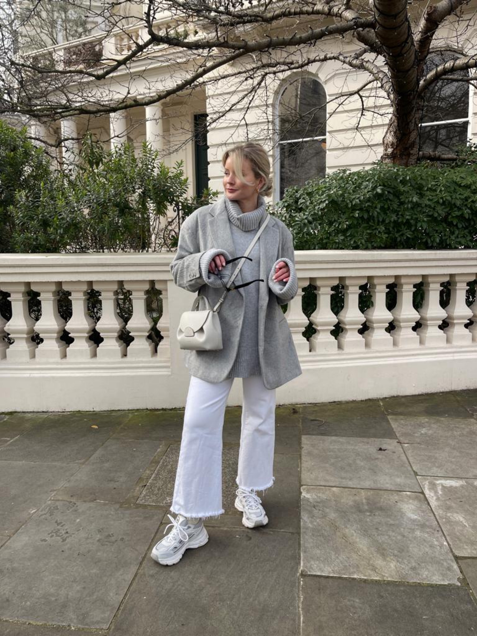 Grey & white outfit inspiration for transitioning into spring. Grey oversized roll neck jumper, grey wool blazer, white wide leg cut off jeans, axel arigato marathon trainers, black prada sunglasses & polene paris handbag  

#LTKshoecrush #LTKeurope #LTKstyletip