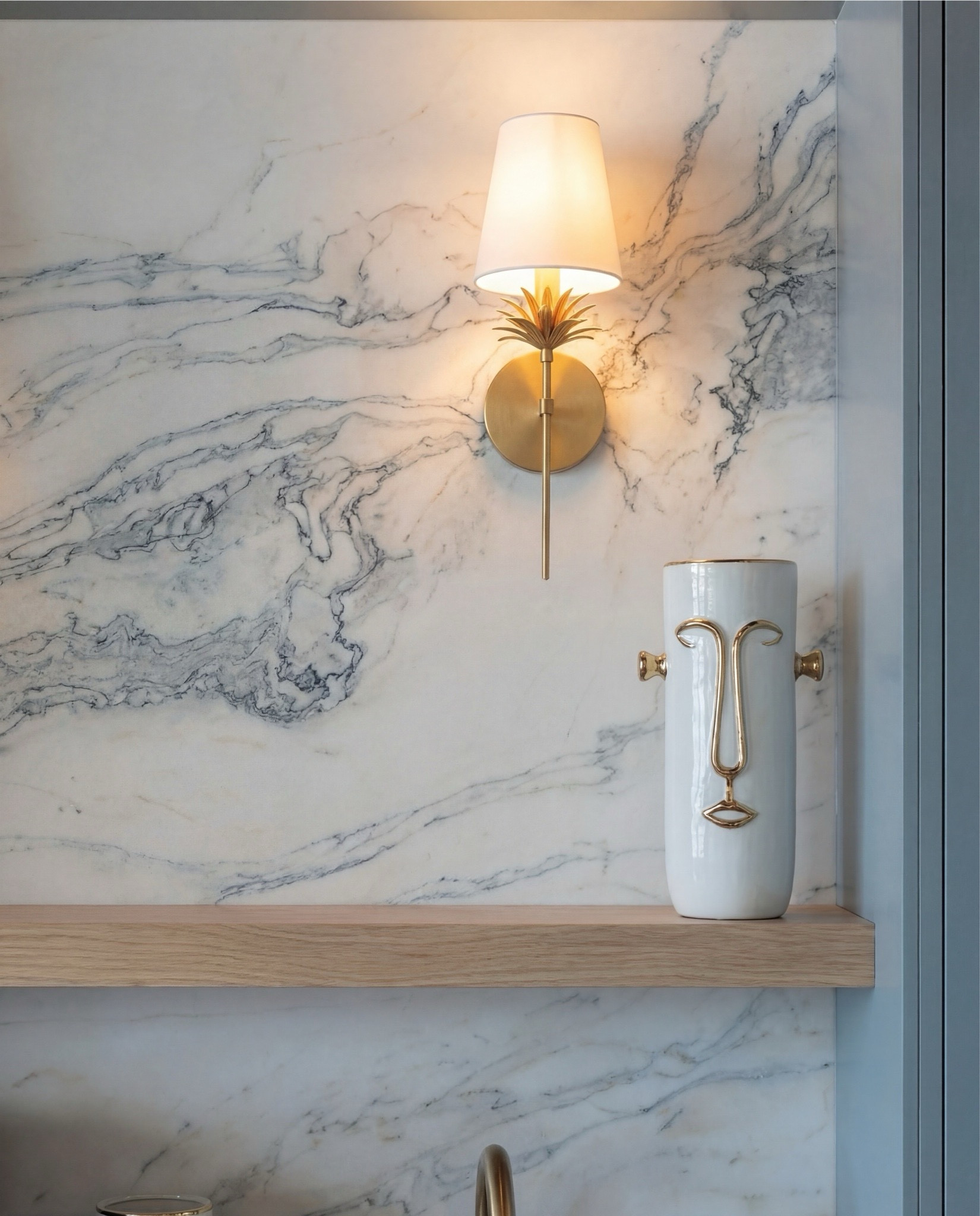 Shop the Look:
• Soft blue paneled cabinetry
• Brass cabinet pulls + drawer handles
• Fluted glass upper cabinet doors
• Marble slab backsplash (gray veining)
• Dark marble countertops
• Brass wall sconces with white shades
• Built-in beverage fridge
• Built-in wine fridge
• Stainless steel coffee maker
• Brass gooseneck bar faucet
• Undermount bar sink
• Light wood floating shelf
• Decorative ceramic face vase (white + brass details)
• Wood ceiling with dark exposed beams
• Vintage-style runner rug (neutral pattern)
• Light wood flooring

#LTKHome #LTKSaleAlert