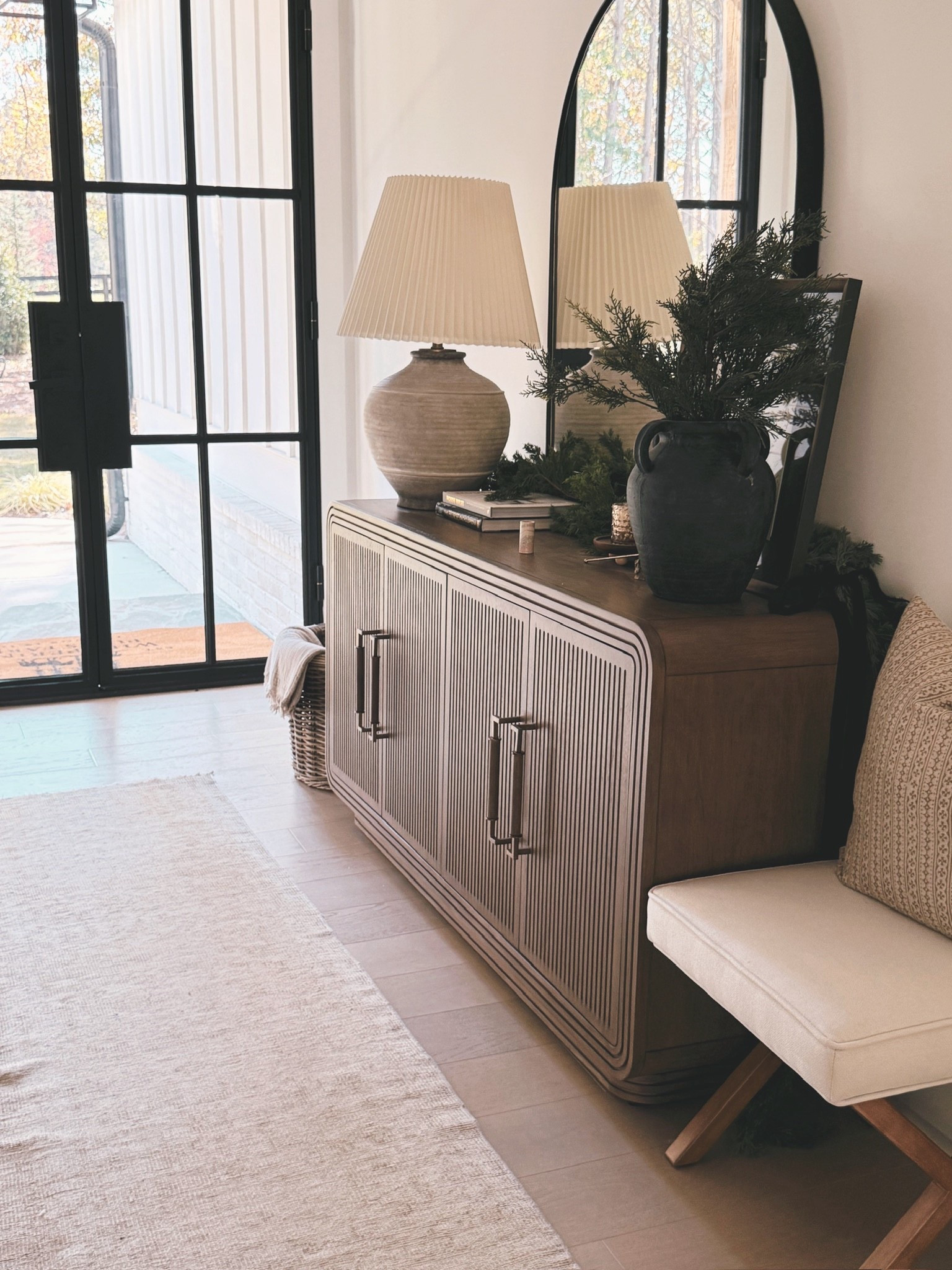 🌲 Imagine coming home to an entryway that feels this calm, elegant, and beautifully decorated…
Natural cedar garland, vintage brass bells, layered neutral artwork, ceramic vases, a ribbed wood console, and an oversized arched mirror create a soothing, cohesive Modern Classic holiday moment.

#porcheandco #neutralholidayvibes #modernclassicentry #holidayinteriors #greenerydecor #brassbells #consoledecorinspiration #sculpturallamp #organictextureddecor #seasonalentreewaystyle

Do you want to bring our dreamy Modern Classic style interior design into your own home? 🏡 You’re in luck! Reserve our Online Interior Design packages today -> https://porcheandco.com/edesign ✨ We can’t wait to work with you & design your home with #porcheandco



#LTKHoliday #LTKSeasonal #LTKHome