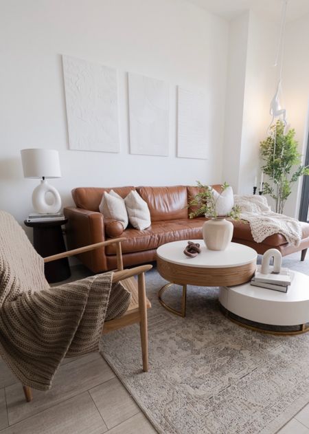 Brown leather sofa, boho modern living room, homary coffe table, hanging monkey light, accent hair, rattan accent chair, oversrtock rug, all modern couch

#LTKhome #LTKstyletip #LTKU