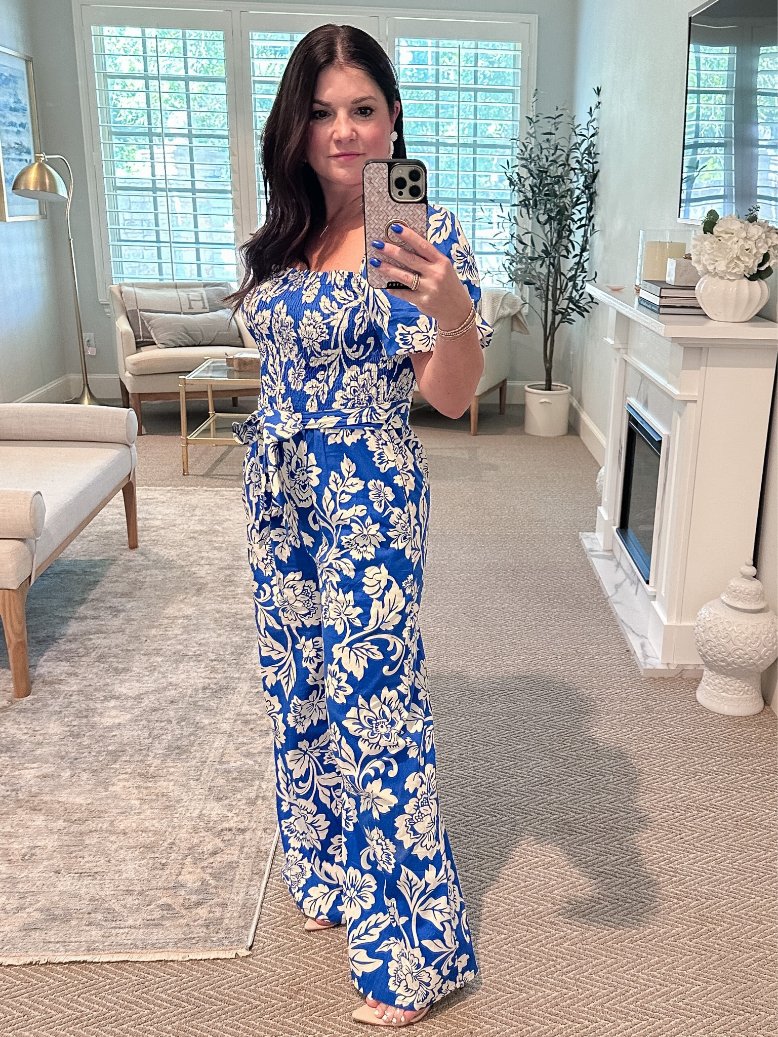 Adorable and affordable blue and white floral jumpsuit features cute puff sleeves, a smocked bodice, a self tie belt, and side seam pockets. I just couldn't resist this beautiful blue and white print. Pair with nude wedges to dress this piece up for dinner, or wear flat sandals for a comfortable yet chic look. Fits true to size. Wearing size small. I’m 5’2”. 