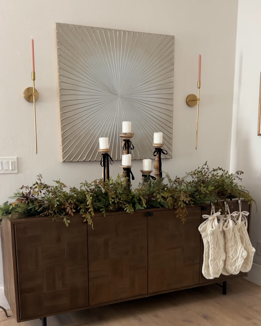 DIY Christmas Garland. I took outdated garland and transformed it into a more modern version by adding filler stems. Wine credenza is Wine Enthusiast, stockings Amazon, custom names are Etsy. All affordable! 

#LTKHoliday #LTKSeasonal #LTKHome