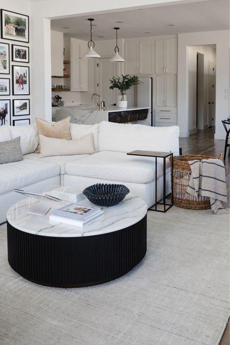 Living room decor we love. Two years in we are loving this white sectional sofa and it’s the best white couch! The performance fabric is so easy to clean. We love this oversized basket for throw blankets. The black and white marble coffee table softens the space. 

#LTKstyletip #LTKhome #LTKsalealert