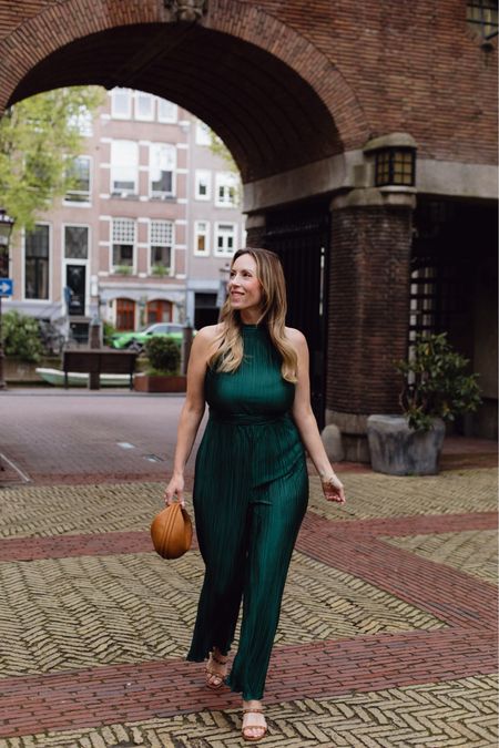 The perfect wide leg jumpsuit in emerald green - also available in several other colors - was perfect for my trip to Amsterdam because it rolled up so small and didn’t wrinkle. I wanted to have one dressy piece with me just in case we went somewhere dressier. I learned quickly that the style around Amsterdam seemed pretty casual. But I still found an excuse to wear this comfy yet chic jumpsuit. Shop the look and everything I packed for the trip over on poshinprogress.com.

#LTKfindsunder100 #LTKmidsize #LTKover40