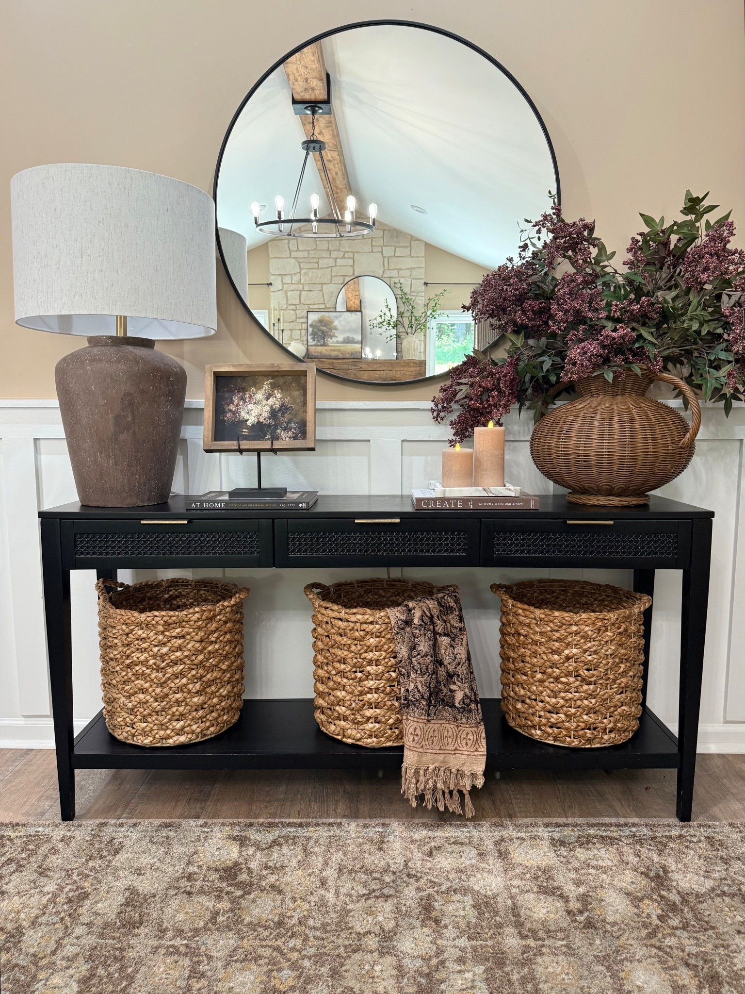 Neutral Console Table Styling with Woven Baskets + Round Mirror

Follow @farmtotablecreations on Instagram for more neutral home styling ideas 🤍

This is one of those setups that instantly makes a space feel pulled together without trying too hard. The black console grounds everything, while the warm woven baskets add texture and function (hello hidden storage 🙌🏼). Layering a round mirror with a simple lamp, framed art, and soft greenery keeps it balanced and not overdone. And that draped throw? It’s the easiest way to add that “designer” touch without adding clutter.

Everything here works together to feel cozy, intentional, and lived-in—exactly how a home should feel.

#consoletable #wovenbaskets #entrywaydecor #homedecor #livingroomfurniture

#LTKHome #LTKSaleAlert