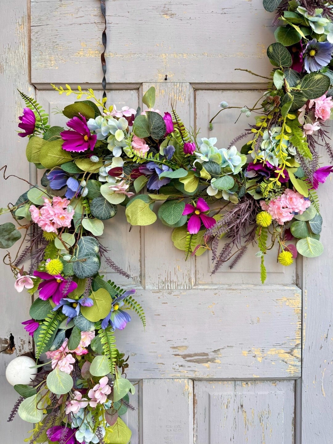 Bring the beauty of a blooming spring meadow into your home with this vibrant handcrafted floral swag. Featuring cherry blossoms, cosmos, hydrangeas, pussy willow stems, and layered greenery, this arrangement adds soft color and natural texture to any door, wall, or entryway. Built on a flexible wired base with hanging loops, it’s easy to style and perfect for creating a welcoming seasonal statement that lasts all spring and summer.

#LTKHome #SpringDecor #FloralSwag #DoorDecor #SpringHome #SeasonalDecor #FarmhouseStyle #CherryBlossomDecor #HydrangeaDecor #FrontDoorDecor #HomeStyling #SpringFlowers #EntrywayDecor #LTKFinds #HomeInspo

#LTKSeasonal #LTKWedding #LTKHome
