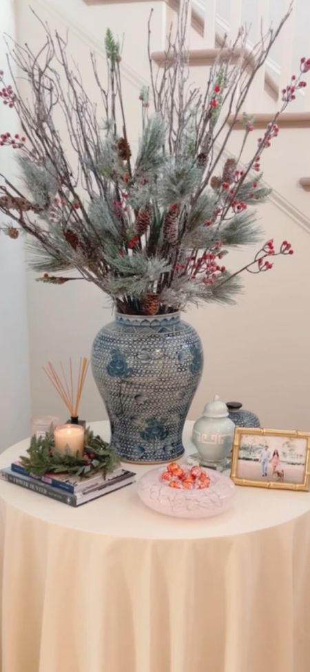 Beautifully styled entry table for the holidays! Christmas stems, winter pine and berry stems in a blue and white ginger jar. Holiday ginger jar  

#LTKhome #LTKSeasonal #LTKHoliday
