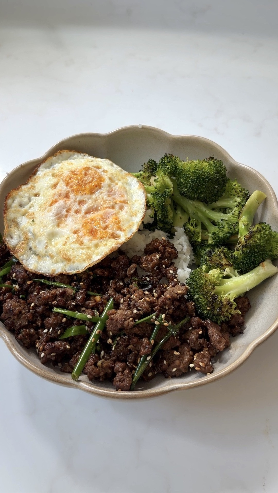 Using @farberware  TrueCook Stainless because the heavy-gauge stainless steel is made to last! Available at Walmart #farberwarepartner #paidlink

Spicy Mongolian Ground Beef Recipe 🌶️🍳🍚

high-protein dinner, made in 30 min and tastes better than takeout. ~30g protein per serving with a fried egg on top

INGREDIENTS
 marinate the beef:
1 lb ground beef
2 tsp shaoxing wine (optional)
1 tsp soy sauce
1/4 tsp baking soda

sauce:
3/4 cup hot water
1/4 cup soy sauce
1 tsp dark soy sauce
1/4 cup brown sugar
1 tbsp cornstarch + 2 tbsp water (slurry)

everything else:
1/4 cup oil
3-8 dried red chili peppers
2 tsp minced ginger
4 scallions, cut on a diagonal
3 cloves garlic, chopped
1 fried egg per serving

INSTRUCTIONS

1. make the sauce: combine hot water, soy sauce, dark soy, and brown sugar. mix the cornstarch slurry separately.
2. heat oil in your pan on high. add chili peppers, ginger, scallion whites, and garlic. cook till fragrant.
3. add the beef and cook till browned.
pour in some of the sauce, simmer, then stir in the slurry till it thickens. 
4. toss in scallion greens till wilt. serve over steamed rice and veggies, topped with a fried egg!

#mongolianbeef #highprotein #easydinner #mealprep #farberwarepartner #walmartfinds #groundbeefrecipes #30minutemeals #dinnerideas