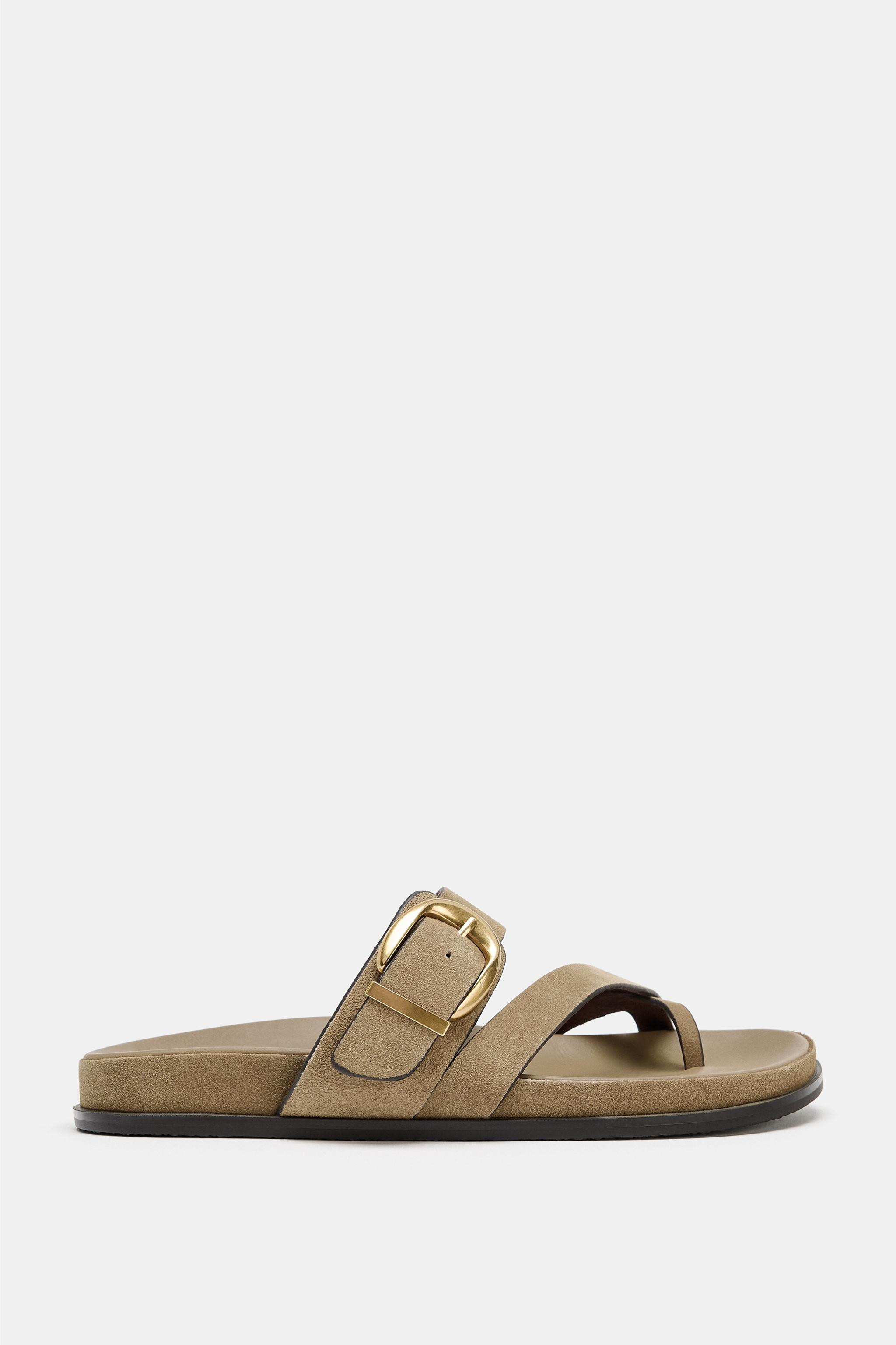 Leather sandals. Front straps with toe post. Metallic buckle detail. Flat rubberized sole. Rounde... | Zara US