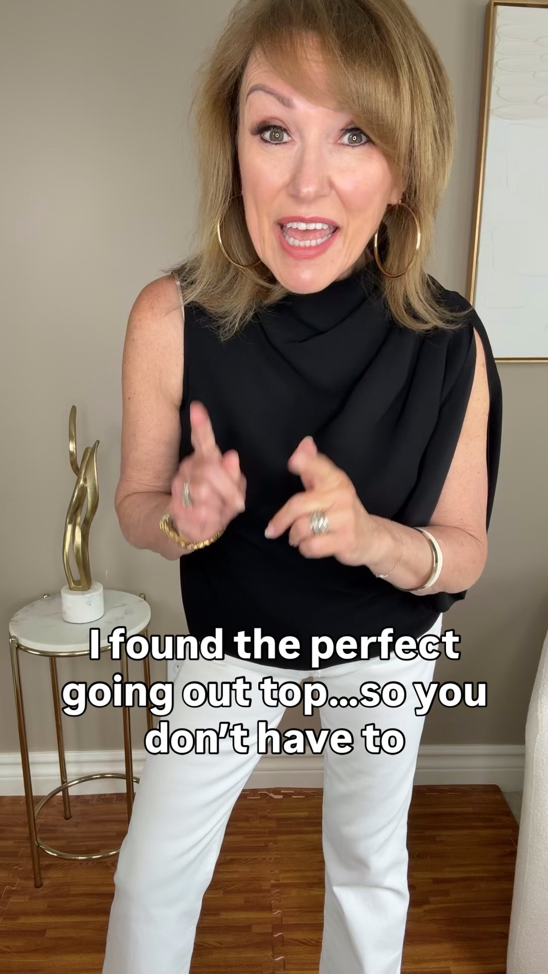 I can’t stop talking about this top from WHBM - and this is NOT a sponsored post!

This top checks all the boxes for a going out top:

1. Chic + Unique
2. Doesn’t cling/easy to wear
3. Doesn’t have to be tucked to look modern
4. Alluring without showing a lot of skin
5. Classic black for all occasions

There’s three different ways I would style this top:

1. With the white pants and white accessories for a daytime brunch look. Add some nude sandals.

2. With dark wash jeans, oversized earrings and an interesting black bag - think studs or fringe. Perfect for a concert look. Black booties or heeled mules to round it out.

3. For a dinner date I would throw on a pair of black trousers and add a bold bracelet stack and carry a silver or gold clutch to match my jewelry metal.  A strappy heeled sandal to keep the dressier look.