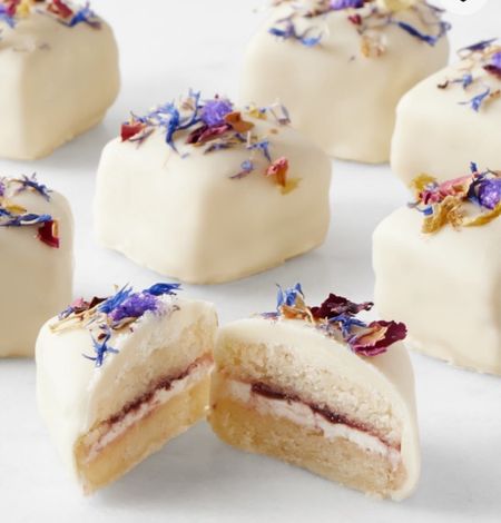 William Sonoma Bridgerton Floral Petit Fours, Set of 30. Lady Whistledown requests the pleasure of your company for tea – and our scrumptious "Bridgerton"-inspired petits fours. The mini morsels feature two tiers of tender vanilla pound cake, layers of luscious mascarpone buttercream and house-made strawberry preserves, and white chocolate fondant. For a fresh finishing touch, the handcrafted treats are sprinkled with organic wildflowers and lavender florets picked from the manor house gardens

#LTKparties #LTKhome #LTKstyletip