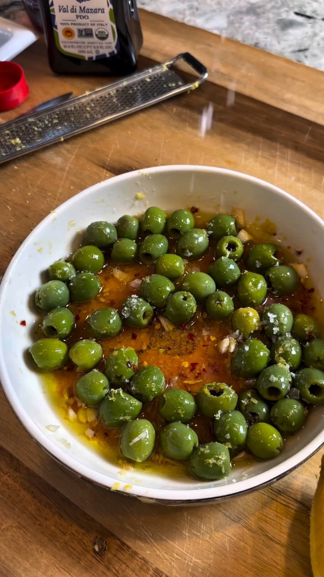 If you love a dirty martini, these marinated Castelvetrano olives are about to be your new obsession. Think upscale happy hour at home, served in the prettiest little bowl.

Olive oil, red wine vinegar, two cloves of minced garlic, the zest of one lemon, a tablespoon of crushed red pepper and flaky salt. Simple ingredients, big flavor. Toss with those buttery Castelvetranos and let that citrus garlic heat soak in.

Eat them right away or let them sit overnight for a melt in your mouth flavor moment. Share with an olive lover. Share with a dirty martini lover. Share with your friend who always orders the appetizer before the drinks.

Comment OLIVE and I’ll send the recipe straight to your DMs

#dirtymartini #olives #easyappetizers #happyhour