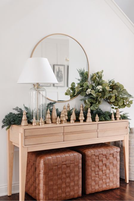Christmas console table styling, wooden christmas trees, tabletop christmas trees, tiered wood christmas tree, champagne bronze spray paint for decor, glass lamp with empire shade, faux eucalyptus stems, faux leather woven cube ottoman

#LTKHoliday #LTKstyletip #LTKhome