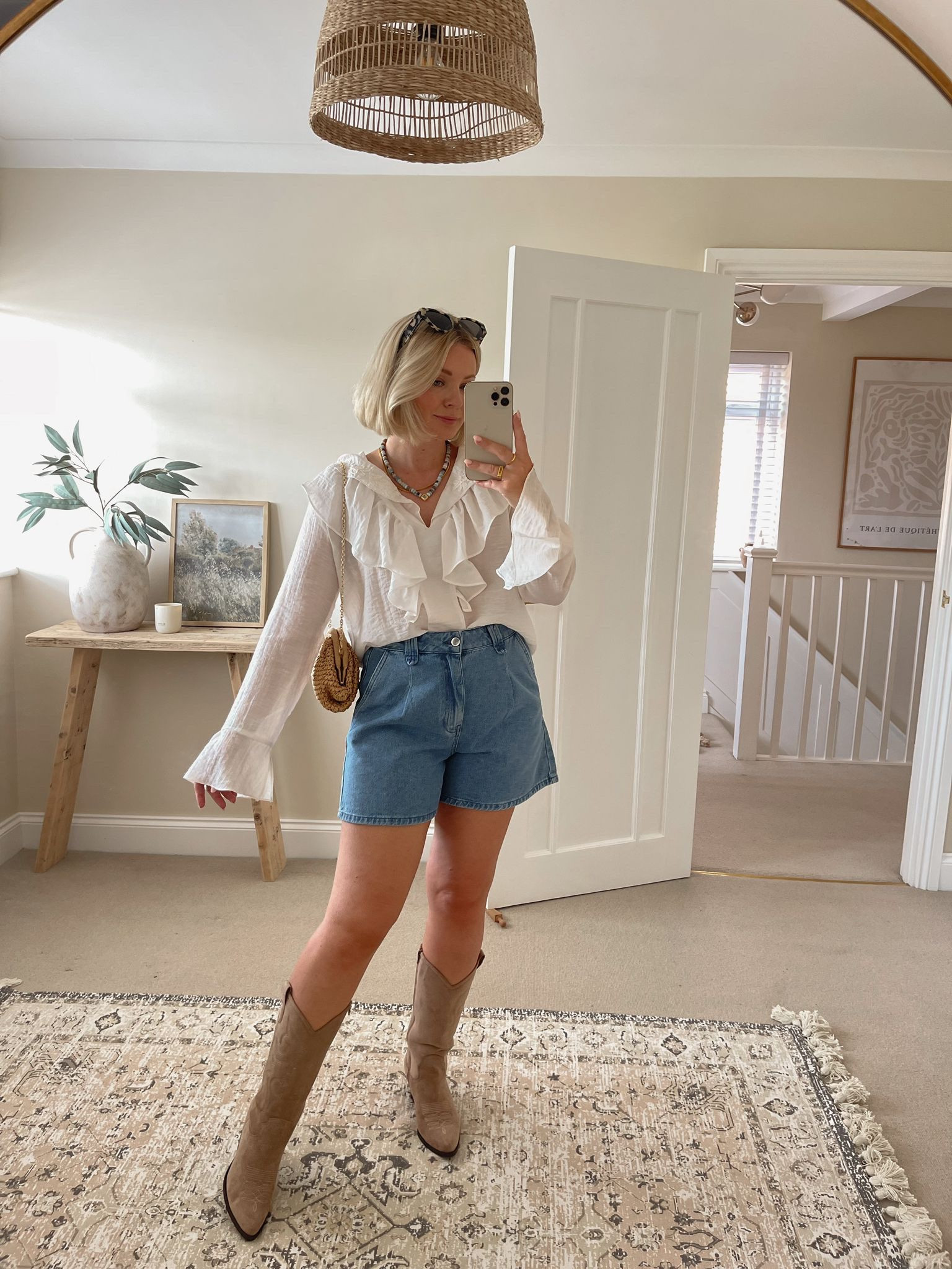 Chic summer festival & Ibiza outfit ideas - white ruffle trim blouse, very x Laura Byrnes denim shorts, beige suede cowboy boots, mango raffia clutch, & other stories tortoiseshell cat eye sunglasses, Carrie Elizabeth blue beaded necklace  

#LTKsummer #LTKuk #LTKstyletip