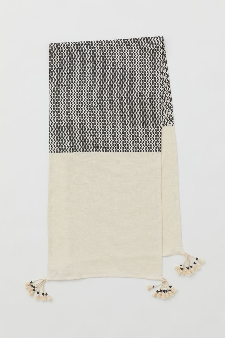 Table runner in a block-coloured cotton weave with braided fringing finished with tassels at each... | H&M (UK, MY, IN, SG, PH, TW, HK)