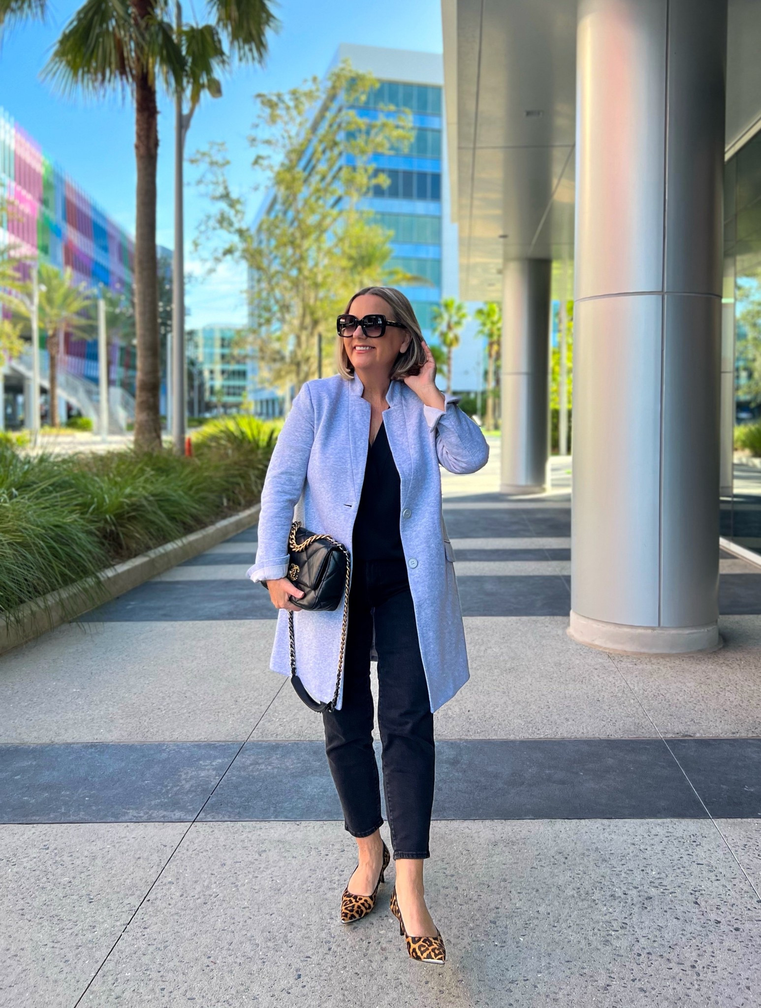 A light coat or a long blazer - it’s a versatile piece. 
Black jeans and leopard kitten heels.