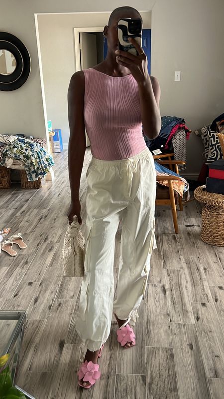 Cargos for spring! White high waisted baggy cargo pants, pink ribbed bodysuit, pink flower heels, white knotted bag  

#LTKSpringSale #LTKfindsunder100 #LTKfindsunder50