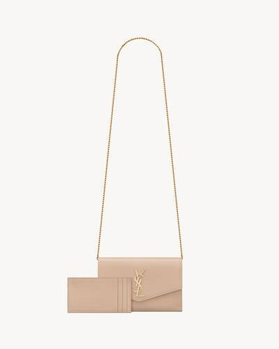 Mini envelope bag decorated WITH THE CASSANDRE, featuring a removable chain strap for shoulder or... | Saint Laurent Inc. (Global)