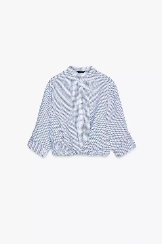 Round neck shirt with sleeves rolled up to below the elbow with tab and button. Front knot detail... | Zara US