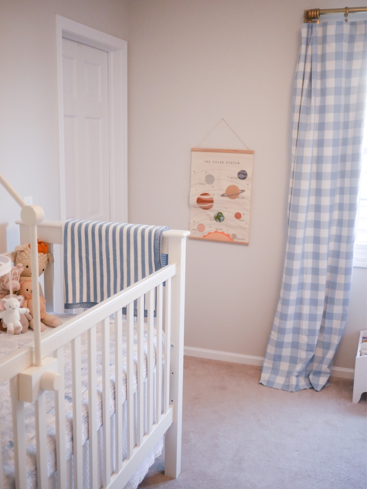 Baby boy nursery with blue gingham curtains and space art

#LTKhome #LTKbaby