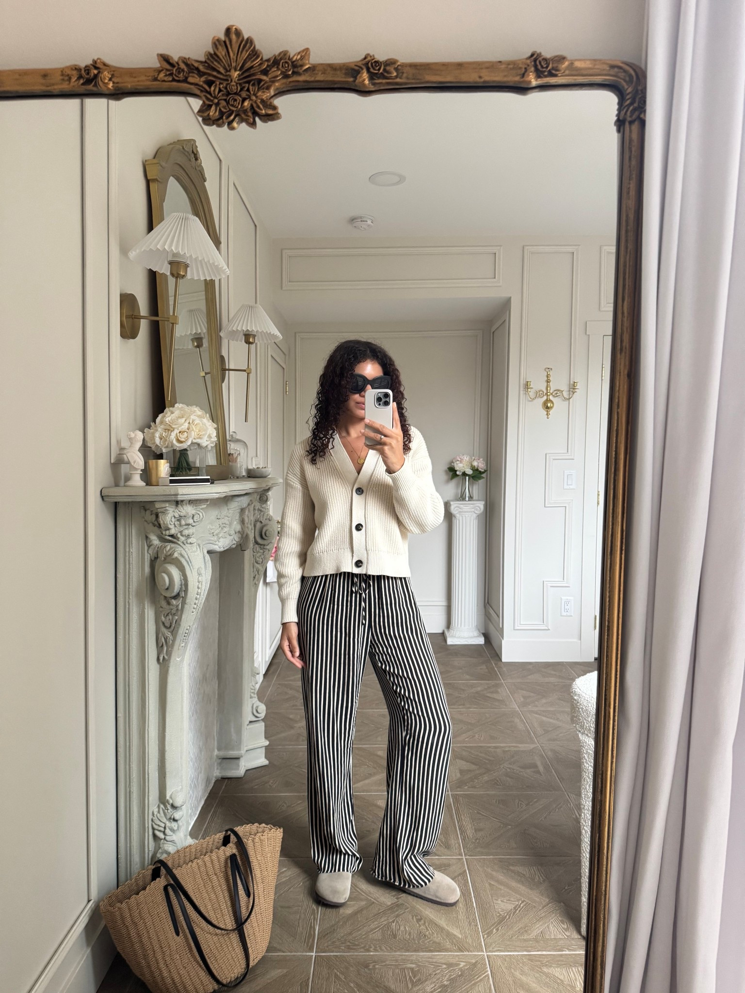 Casual spring outfit: striped pants, cardigan, clogs, and straw bag 

#LTKootd