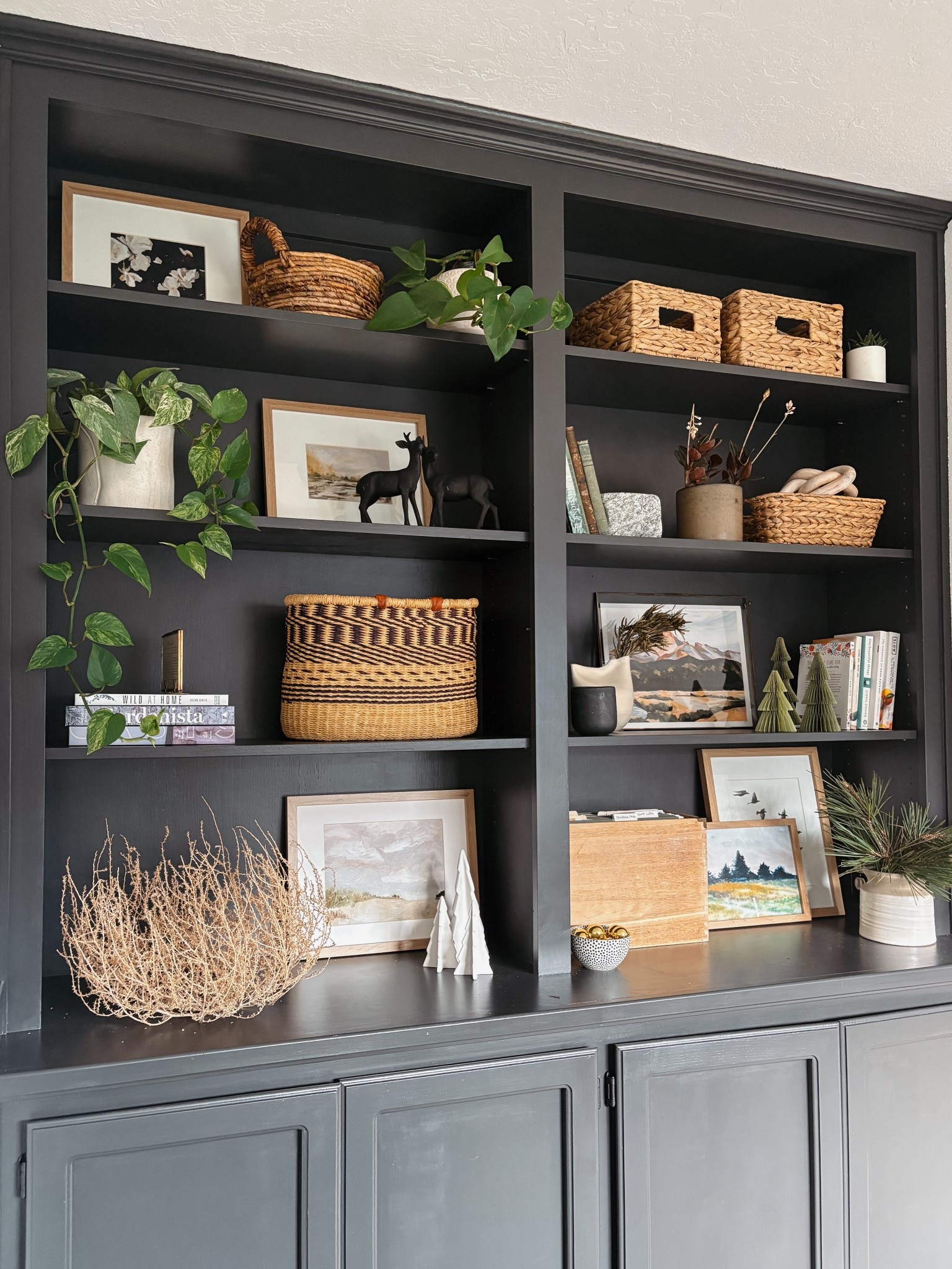 Bookshelf styled for Christmas! Neutral decor, pieces like white Christmas tree, trees, and black reindeer and green paper trees mixed in with books, vases, and baskets for just a touch of festive

#LTKHome #LTKSeasonal #LTKHoliday