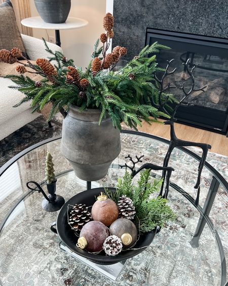 A large vase of holiday greenery and a bowl full of ornaments are perfect for coffee table styling. I added my metal reindeer and a candle as well  

#LTKhome #LTKSeasonal #LTKHoliday