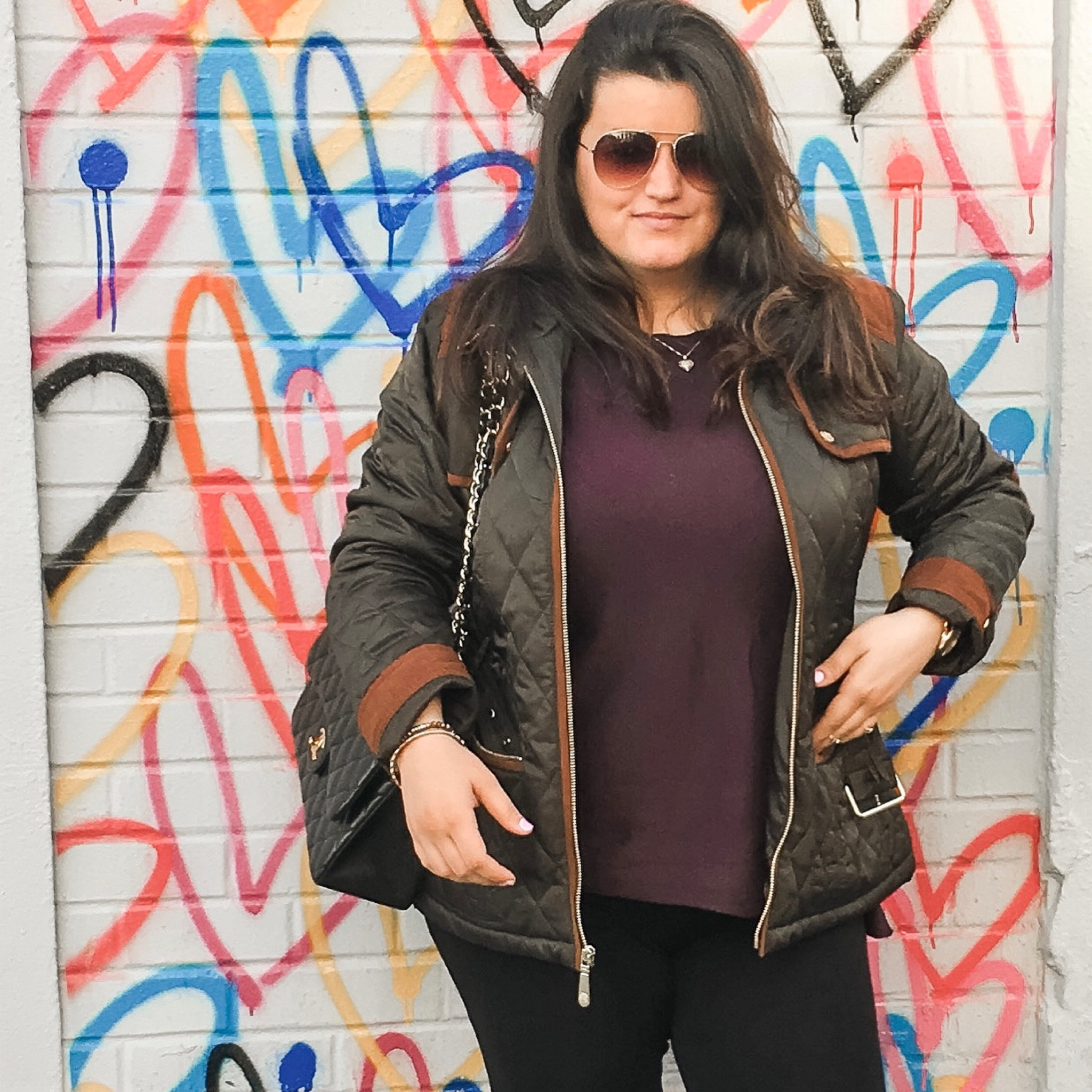 Fall is one of my favorite seasons for fashion. The crisp browns and yellows. The light jackets and sweaters. The boots. In this photo my hair is blown out. I’m wearing aviator sunglasses, a dainty necklace, a quilted green jacket, long thin purple sweater, black high waisted pants, and knee high boots. Of course paired with my Chanel. I’ve worn this outfit to brunch, work, and school 

#LTKworkwear #LTKSale #LTKcurves