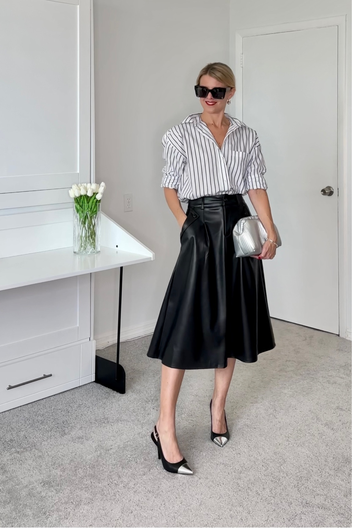 Full pleated faux leather skirt with a striped button down shirt.    

All true to size.  
The skirts smallest size is a 4,  it is a size small.   I'm an XS/0.  I altered it to fit.   It does have a belt that would have helped this fit, but I took it off.  

#LTKHoliday #LTKfindsunder50 #LTKSeasonal